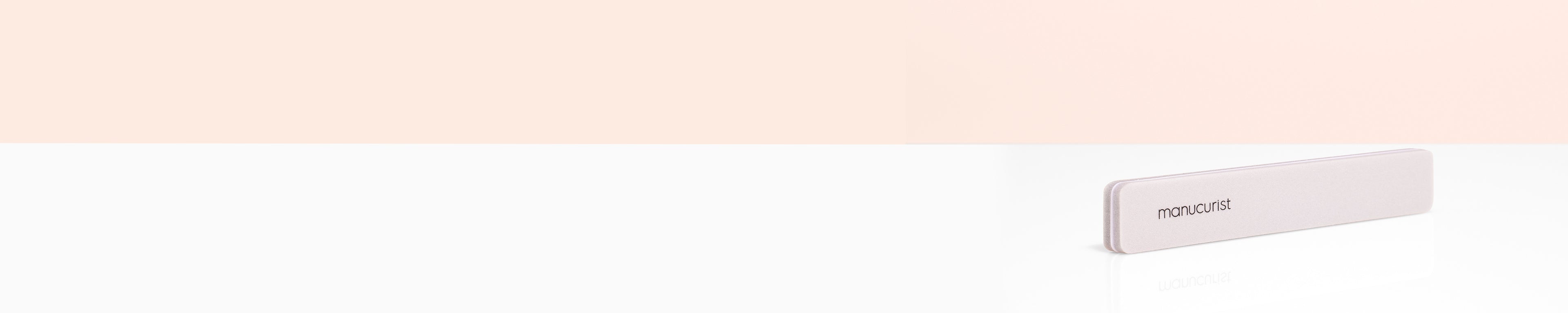 A minimalist pale pink rectangular case labeled not just sits on a white surface against a light beige background, positioned toward the right side of the image.