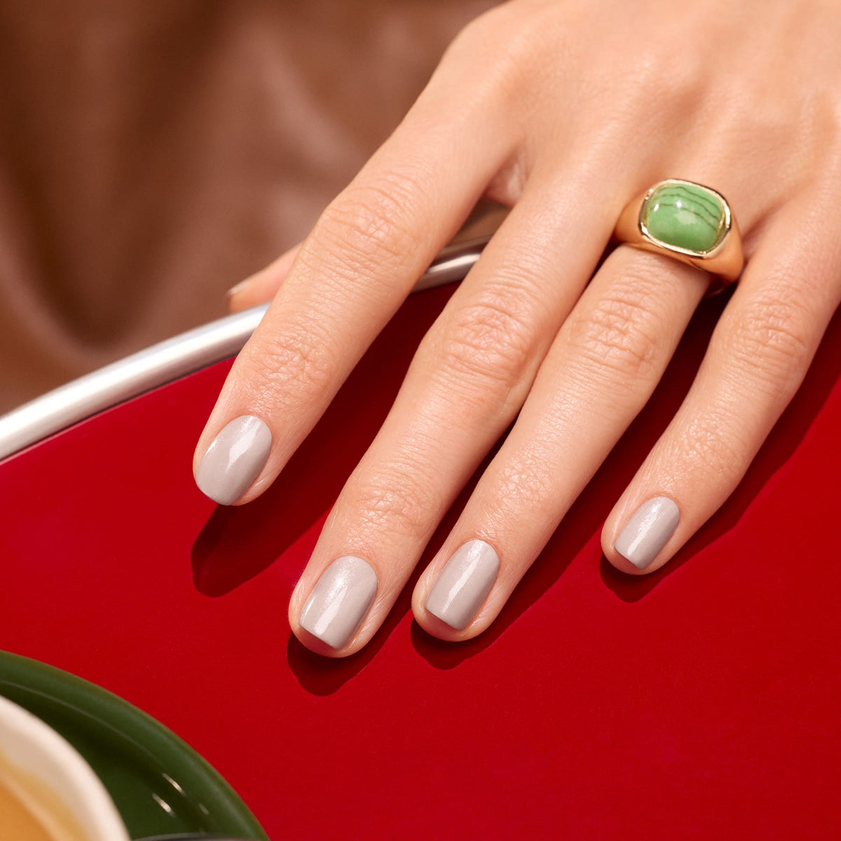 A hand with neatly manicured nails in Manucurist&