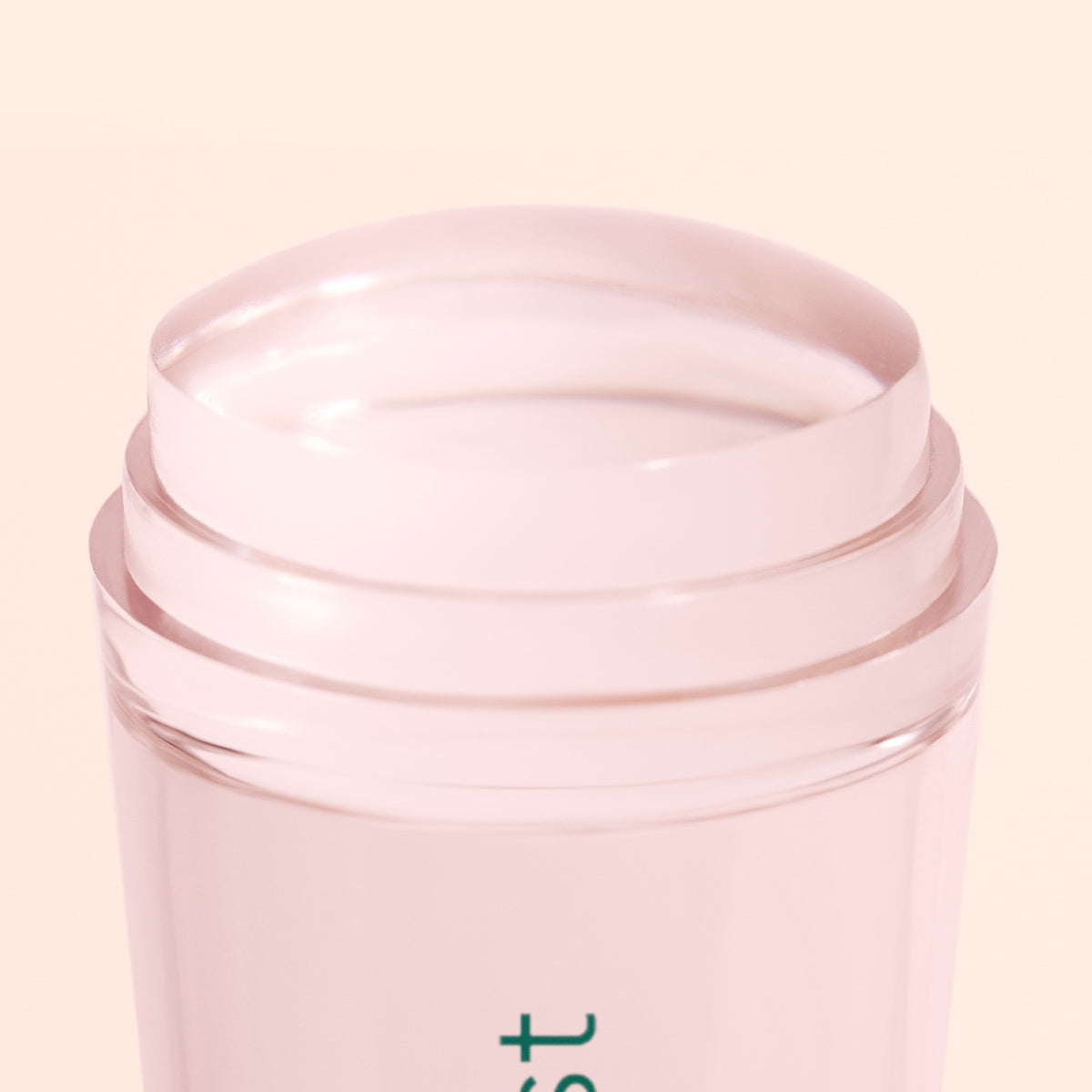 A close-up of the Manucurist Mani Stamper, a light pink translucent twist-up container with a clear, rounded solid top—ideal for flawless French tips or as a mani stamper—set against a pale background.