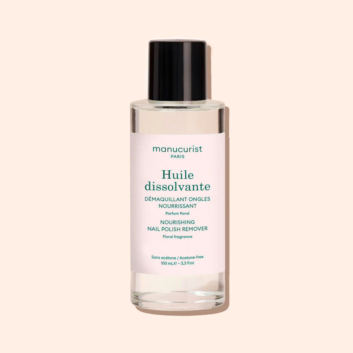 A clear bottle with a black cap contains Manucurist&
