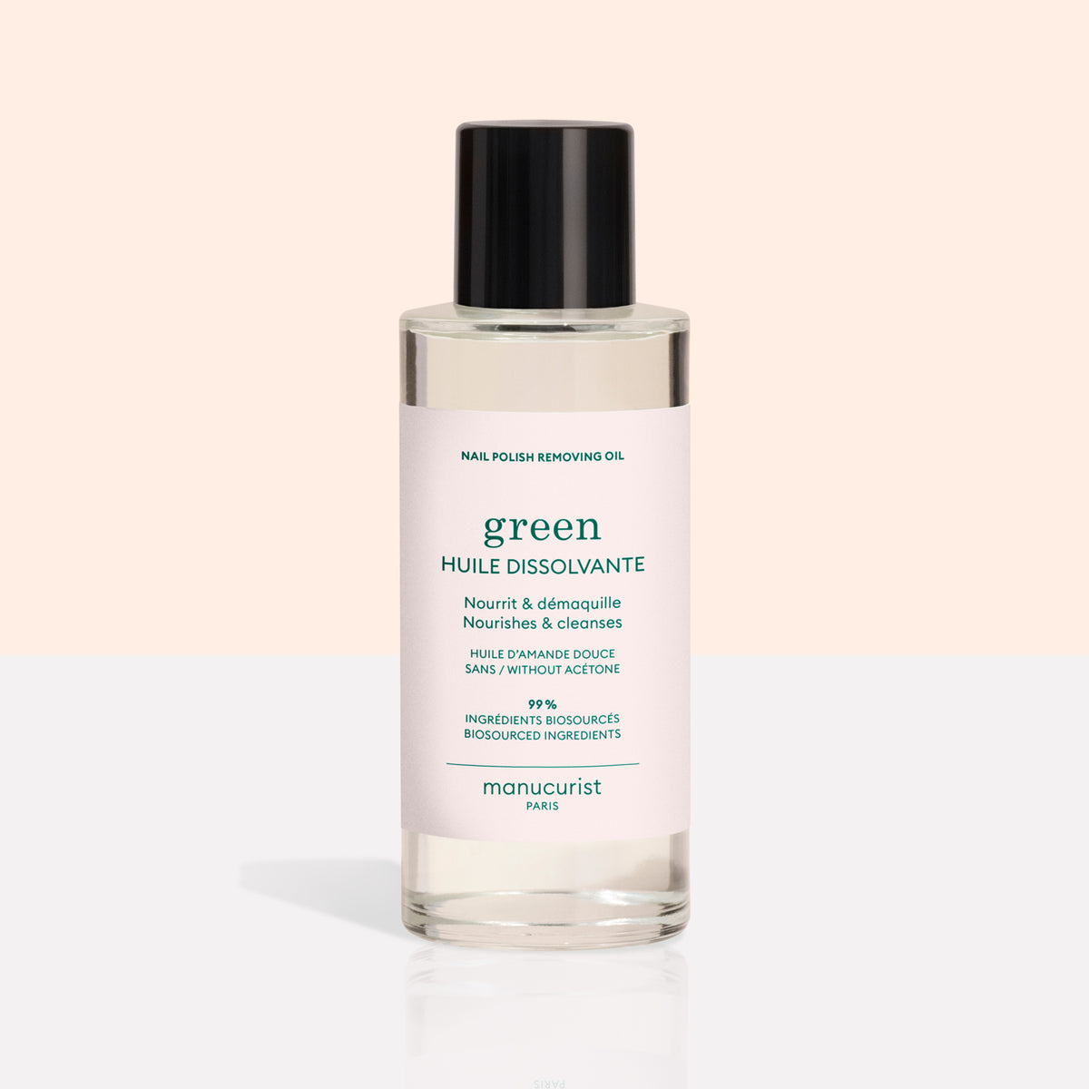 A clear bottle with a black cap contains Manucurist&