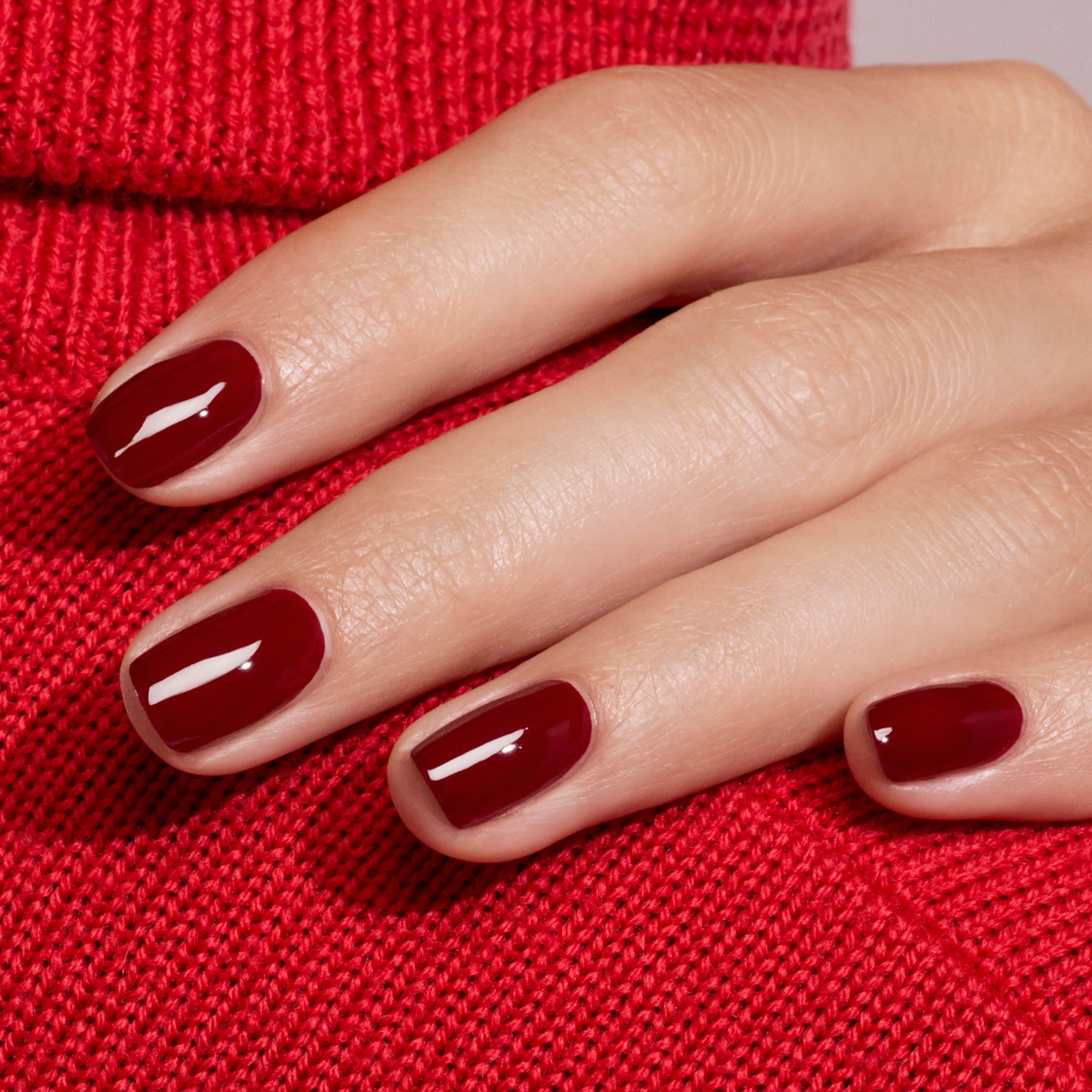 A hand with neatly manicured nails painted in Manucurist&