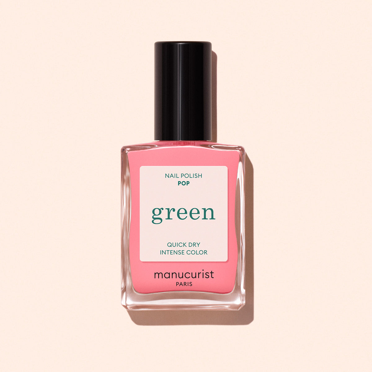 A bottle of Manucurist Pop nail polish in electric pink is shown on a light beige background. The label features "Nail Polish Pop," "Quick Dry Intense Color," and "green.