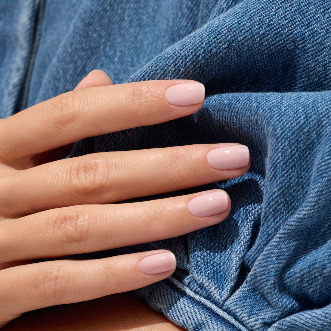 A close-up of a hand with neatly manicured nails painted in Manucurist&