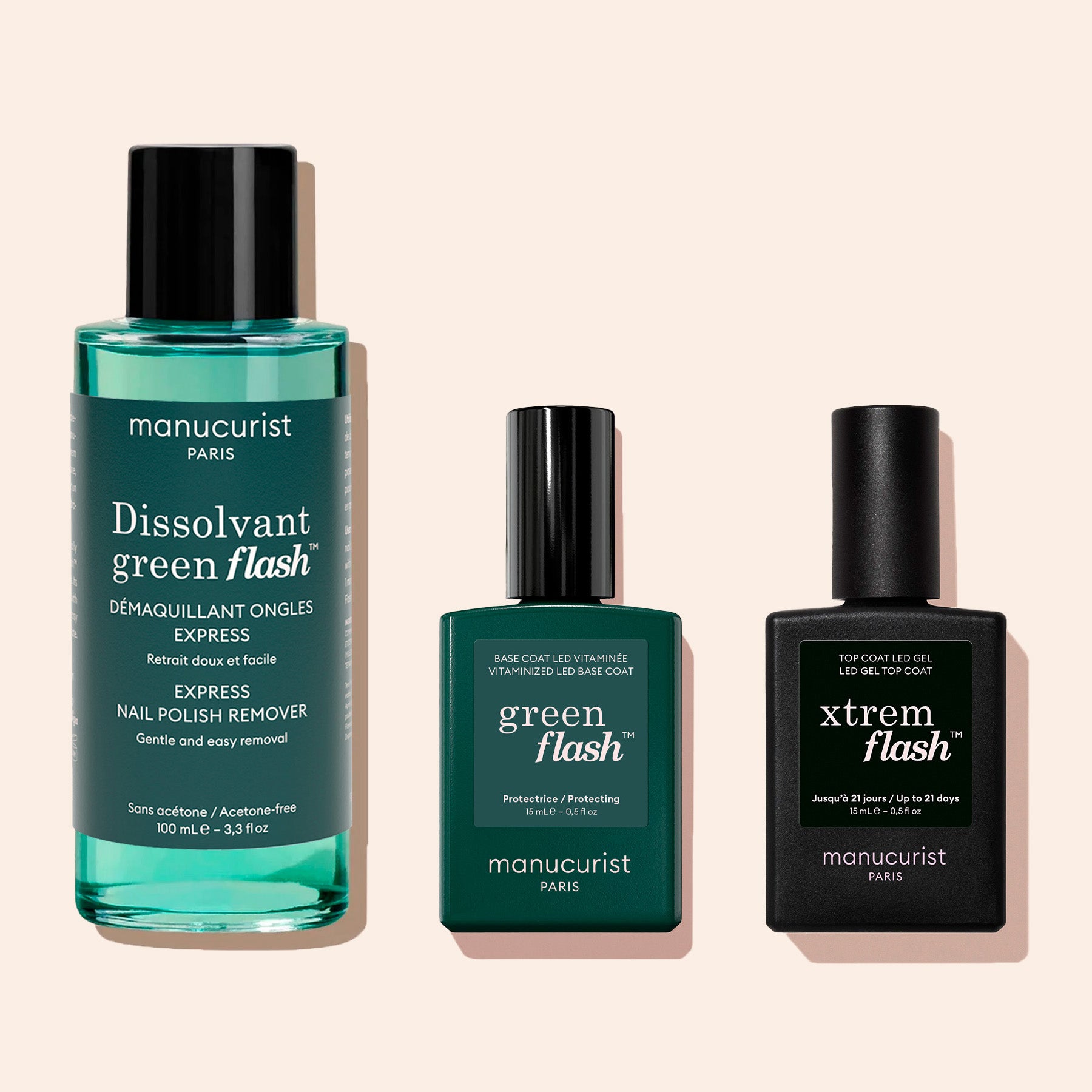 Three Manucurist products: Green Flash™ Gel Polish Remover (100 ml), Green Flash base coat, and Xtrem Flash top coat in green and black packaging, displayed on a beige background.