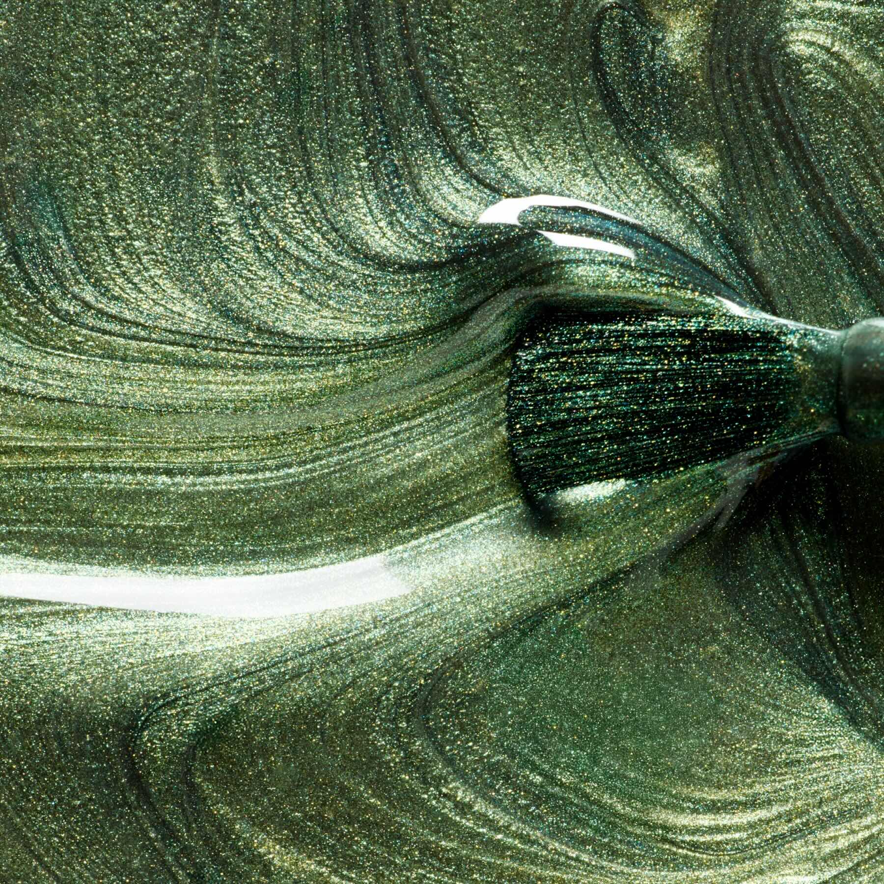 A close-up of a brush swirling Manucurist&