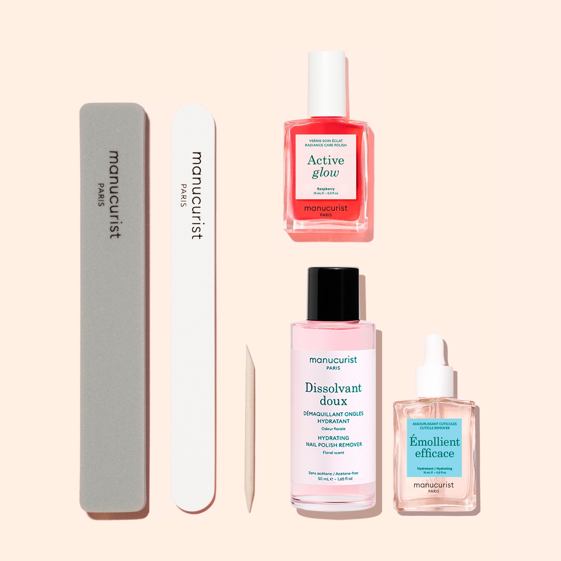 Discover the Manucurist Active™ Discovery Kit: five essential manicure tools arranged on a pale background to elevate your nail care routine. This kit includes a grey nail file, a white nail file, a wooden cuticle stick, pink Active Glow nail polish, pink nail polish remover, and Emollient Efficace—a clear bottle specially formulated to hydrate nails and support effective treatment.
