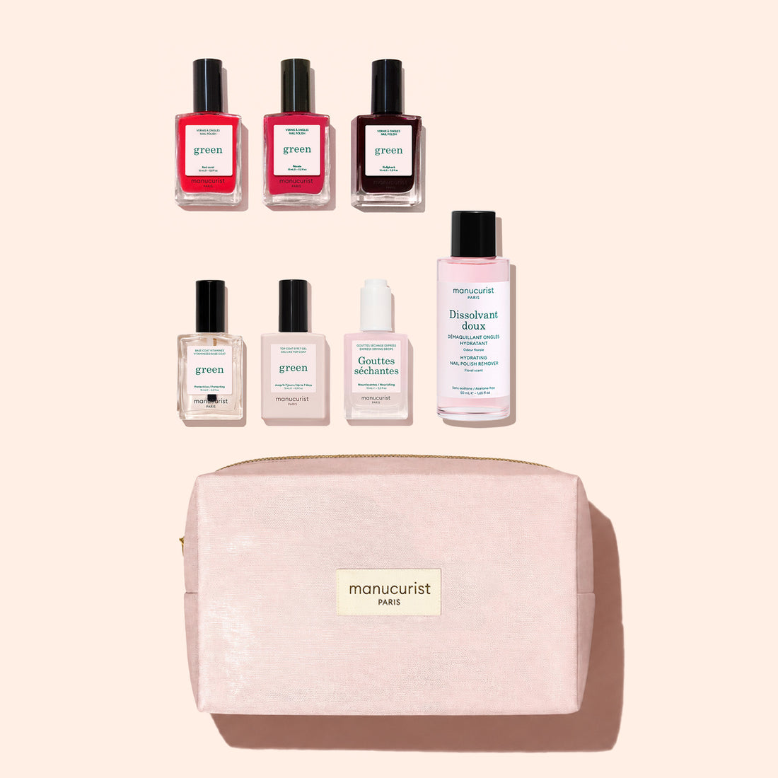 Six gel-effect Manucurist nail polish bottles, one nail polish remover, a small bottle, and a pink organic cotton pouch with a gold “manucurist PARIS” label are all arranged neatly on a pale background, creating the chic Manucurist Starter Kit.