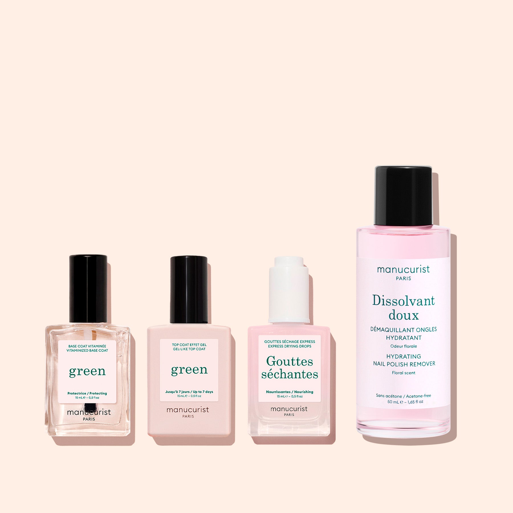 Four Manucurist nail care products, including the Vitaminised Base Coat Green™, with KeraHCE+ to strengthen nails, are lined up on a soft pink background. The tallest bottle on the right is a pink liquid nail polish remover.