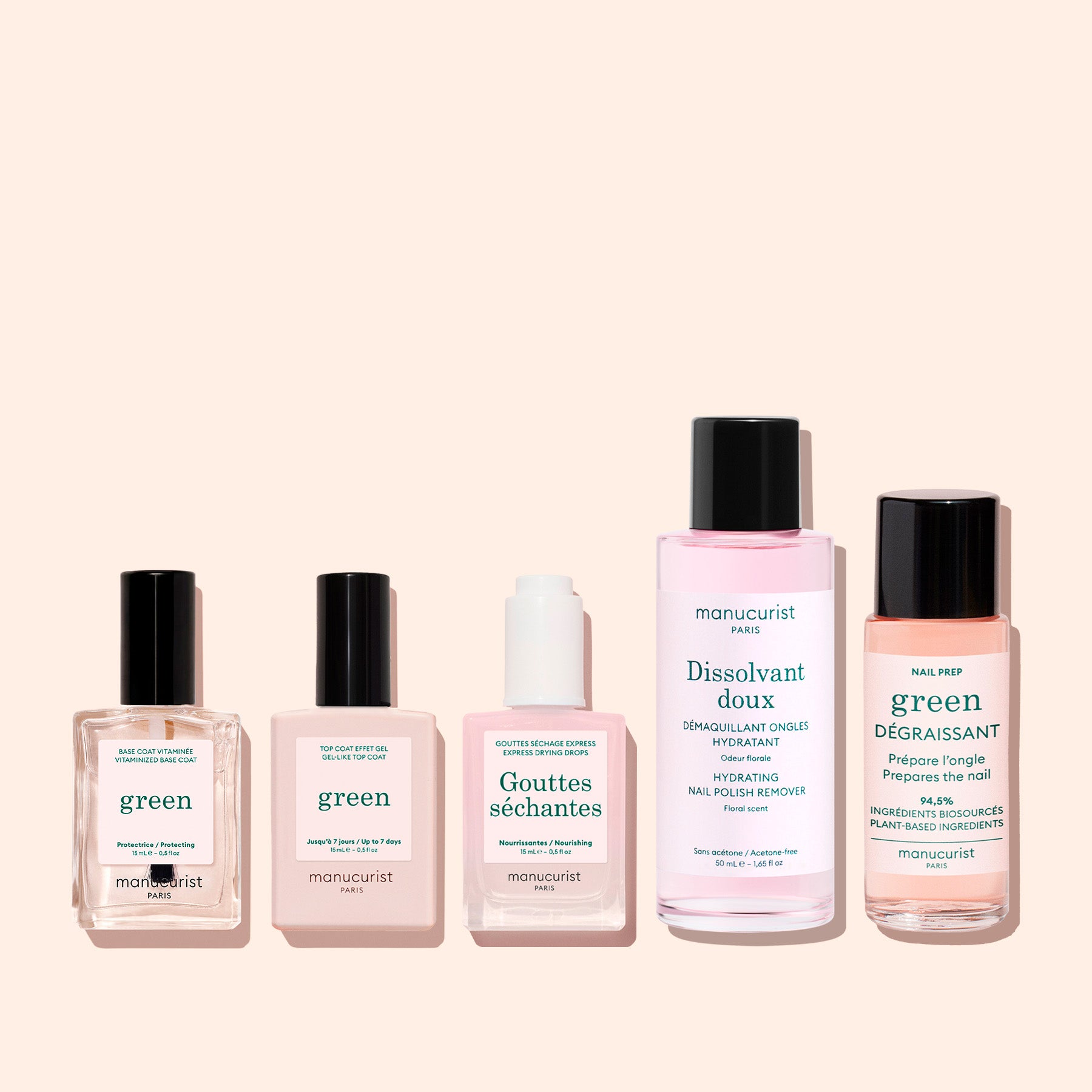 Five Manucurist products from The Essentials of the Green™ System—green nail polish and nail care treatments in clear and pale pink bottles—are arranged side by side on a light beige background, perfect for an eco-friendly manicure routine.