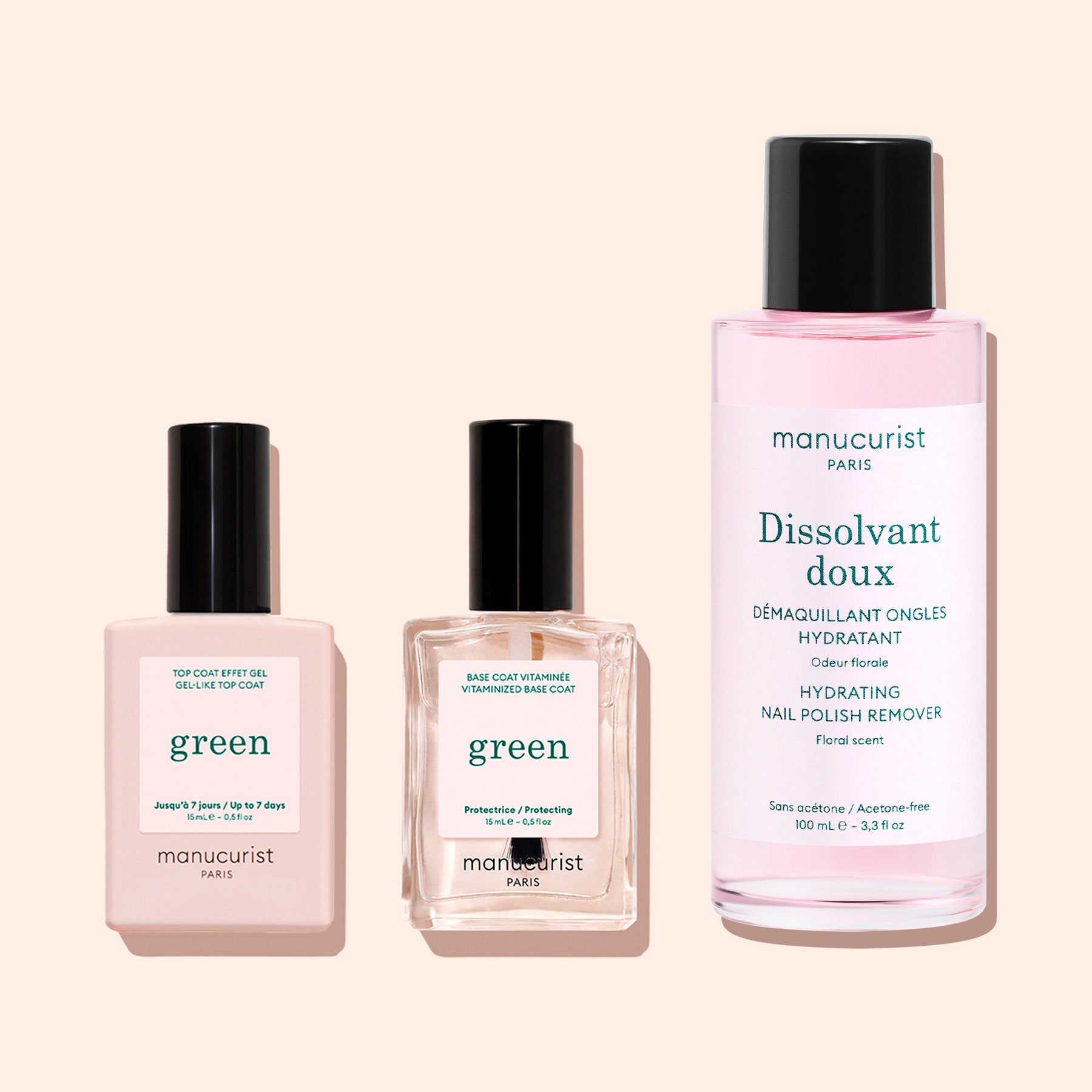 Three manicure essentials from Manucurist’s Green line—a Sunshine Top Coat, a vitaminized plant-based base coat, and a hydrating nail polish remover—are displayed on a light beige background.