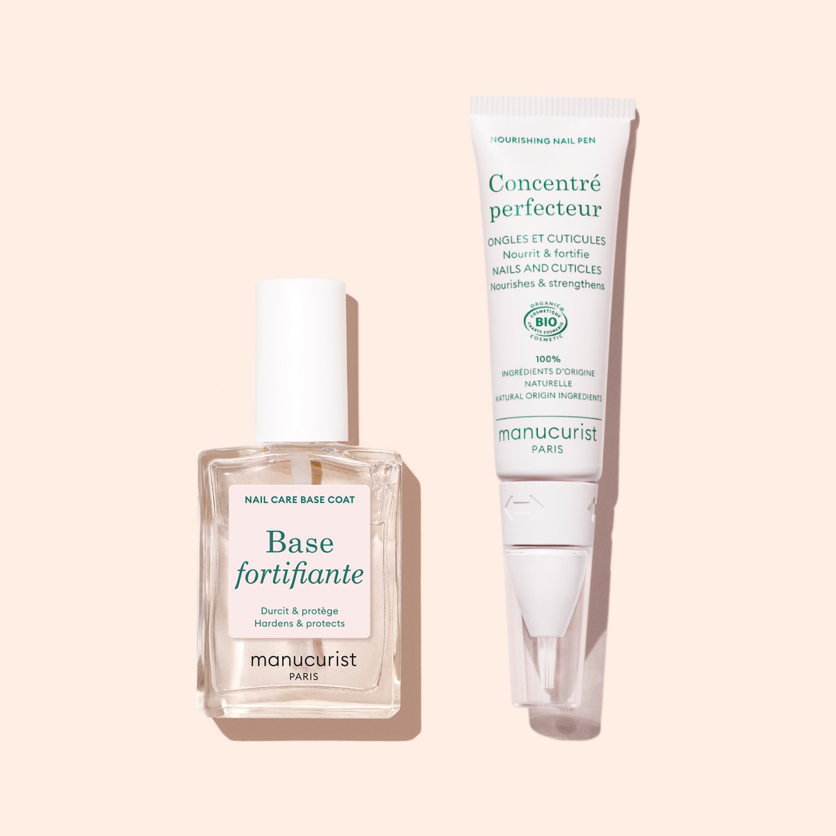 A bottle of Manucurist Force Nail Hardener and a tube of Manucurist Concentré Perfecteur for nails and cuticles are displayed side by side on a light beige background to help strengthen nails.