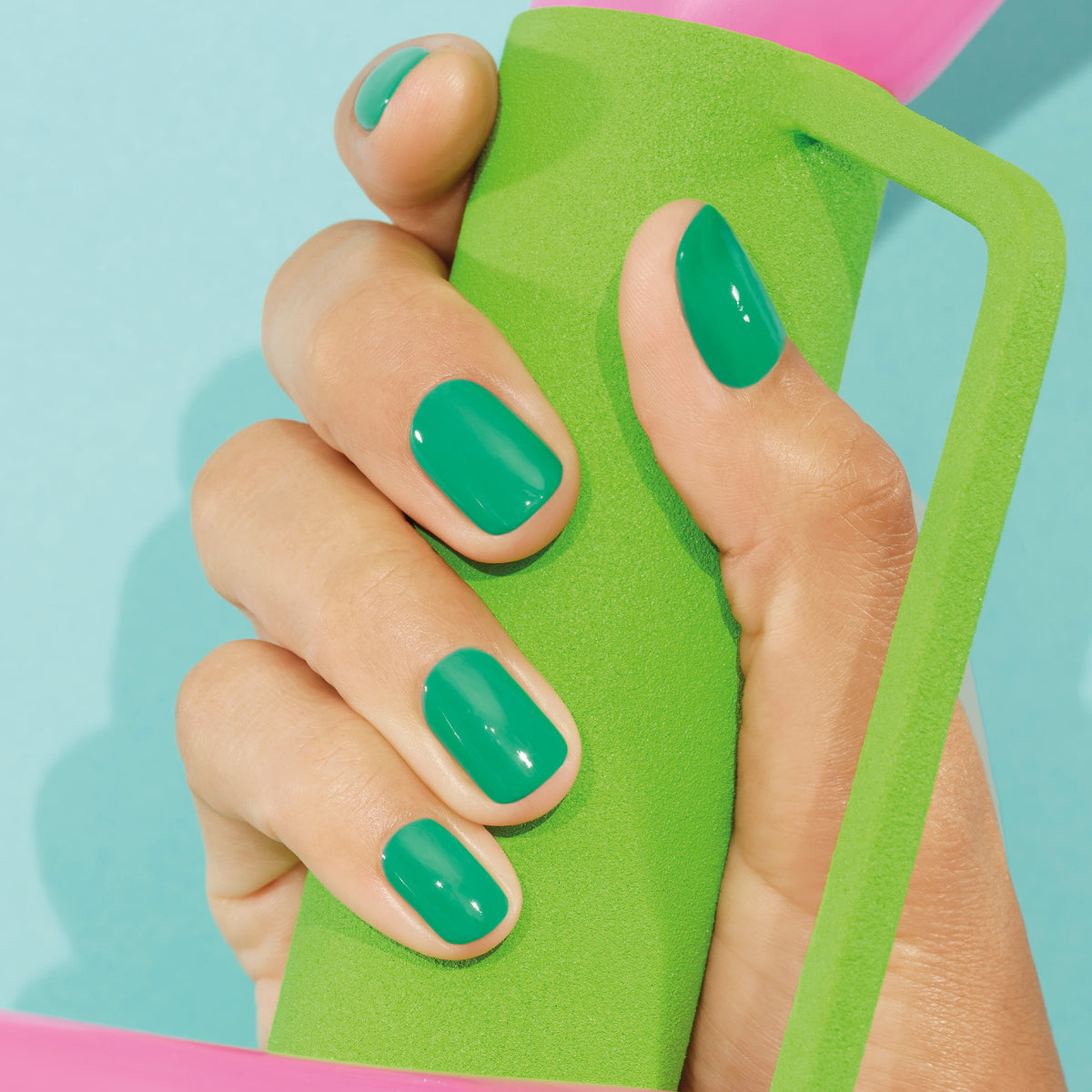 A hand with neatly manicured nails painted in Manucurist&