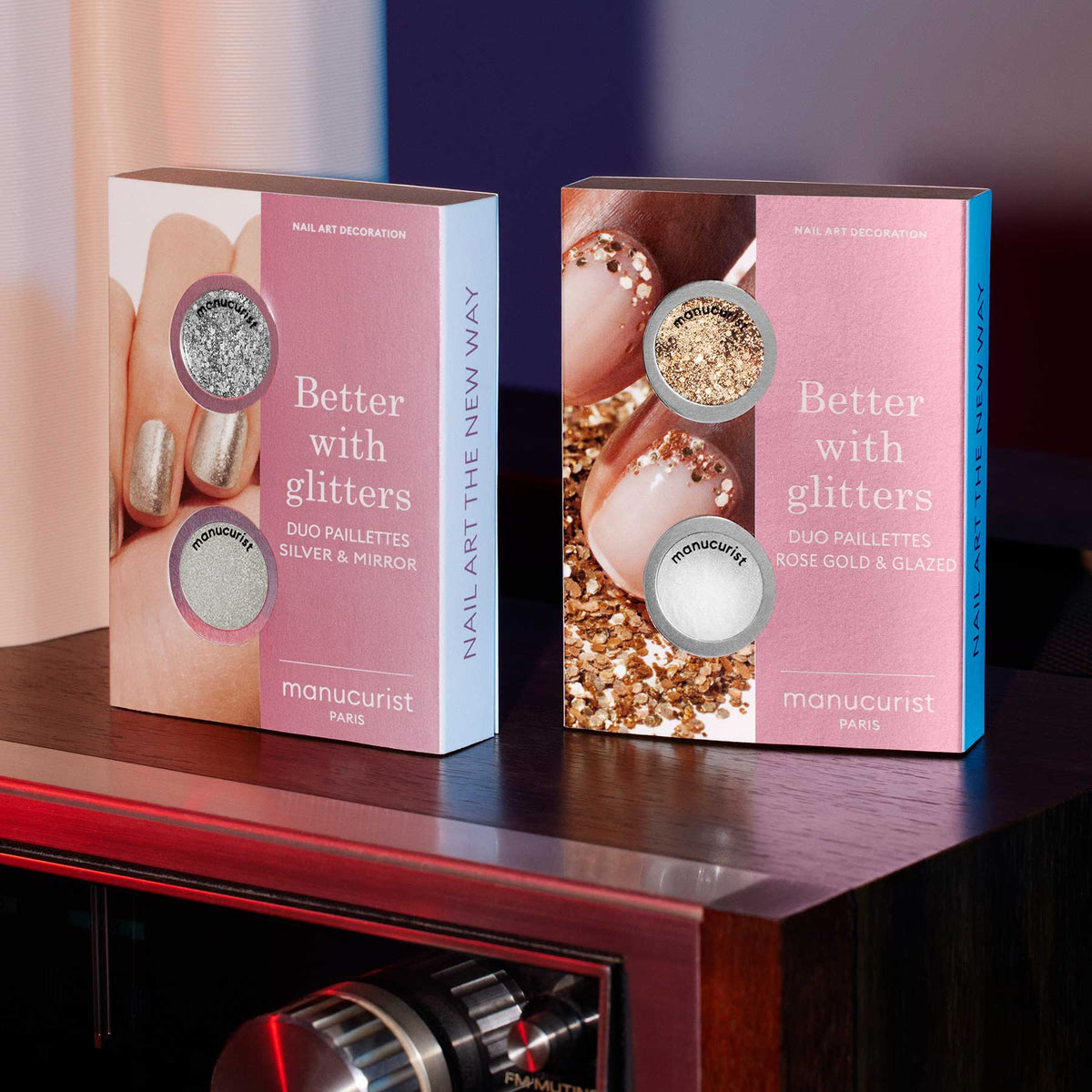 Two boxes of Manucurist Glitter Duo Rose Gold Glazed are shown, each featuring glittered nails on the packaging. One set offers silver and mirror effect glitters, while the other includes rose gold and glazed for sparkling nail art.