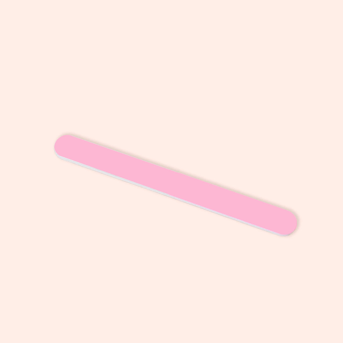 A Manucurist 3-way polisher with rounded edges lies diagonally on a light beige background.