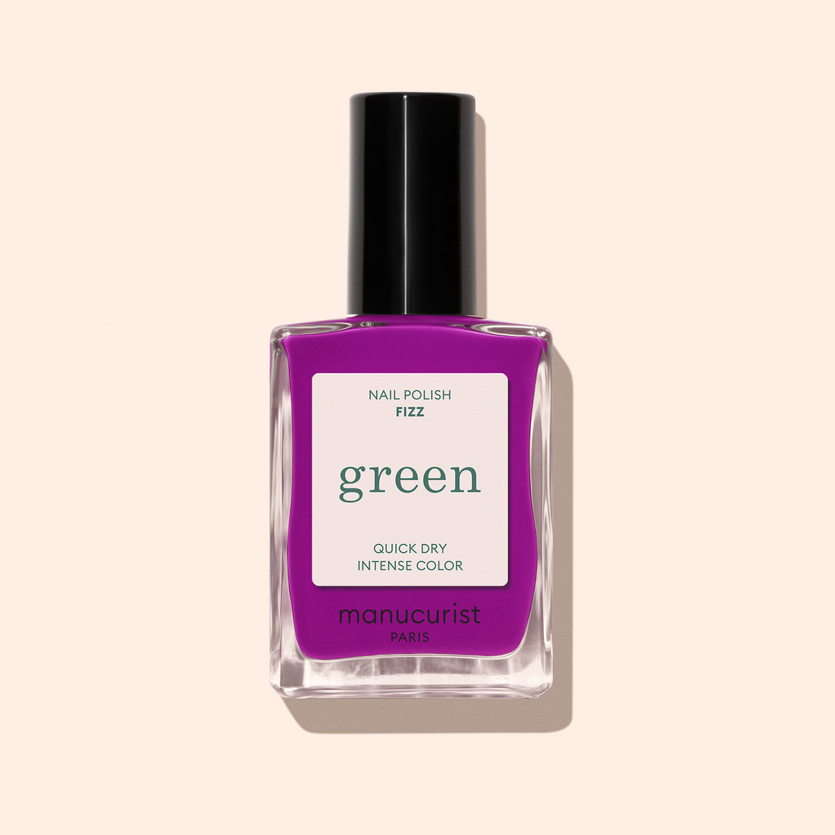 A bottle of Manucurist Fizz nail polish in a bright purple shade, featuring a black cap, is shown against a light beige background.