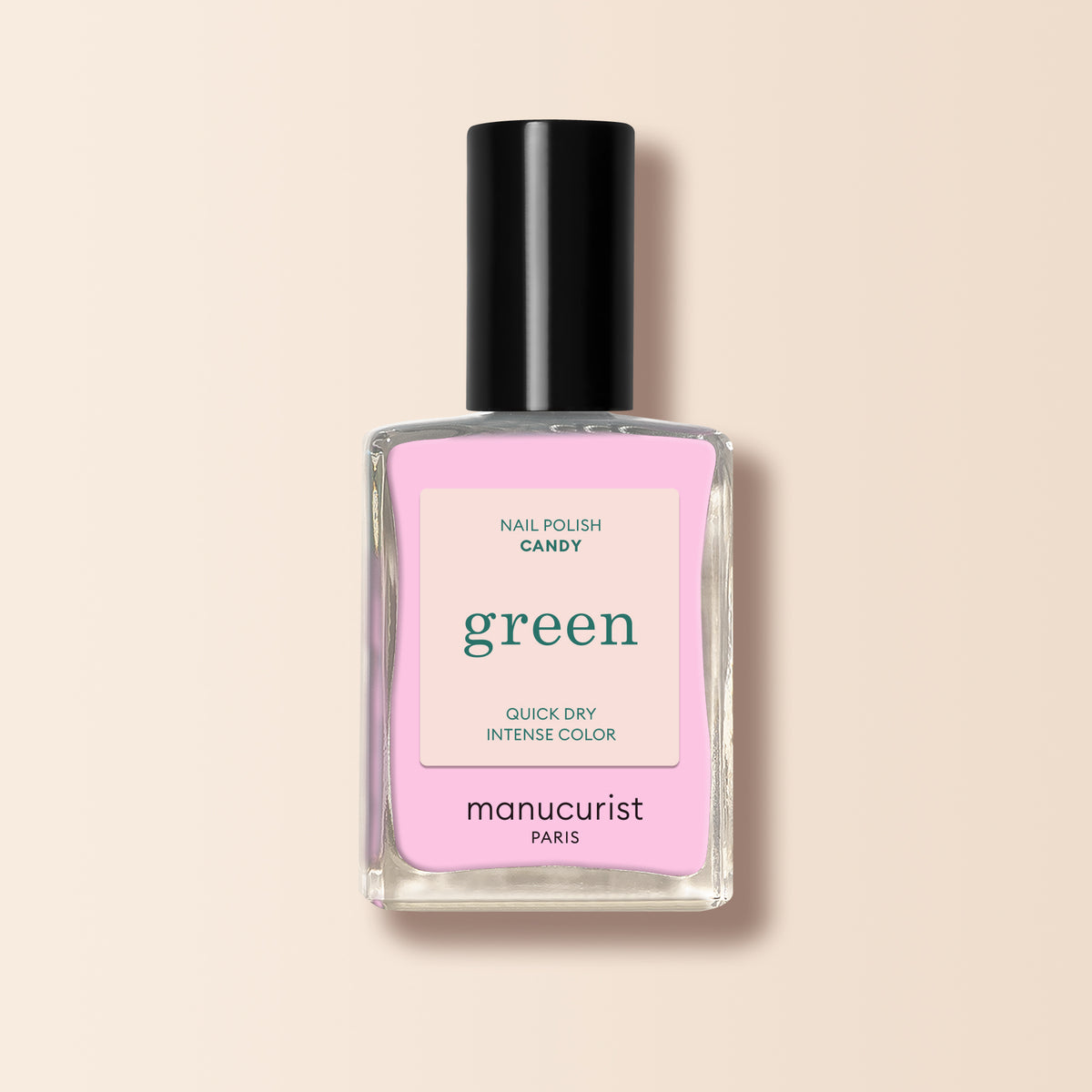 A clear glass bottle of Manucurist Candy nail polish with a black cap and a pink and white label reading "Nail Polish Candy, Quick Dry Intense Color, manucurist Paris.