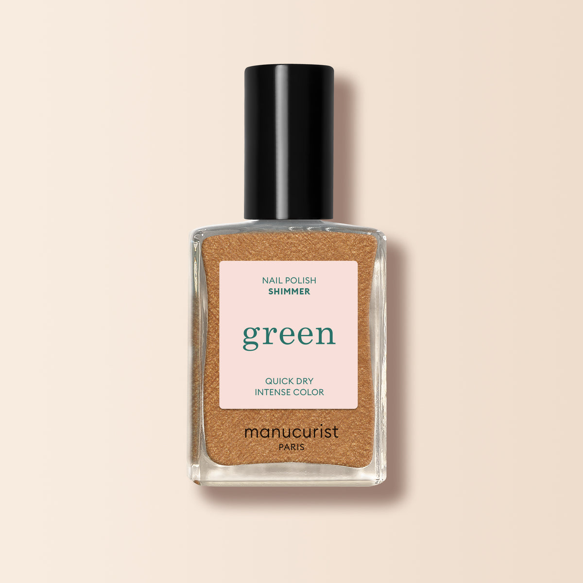 A bottle of Shimmer, a honey-glazed bronze nail polish with cool undertones from Manucurist. The label reads Nail Polish Shimmer, Quick Dry, Intense Color. It features a black cap and beige background.