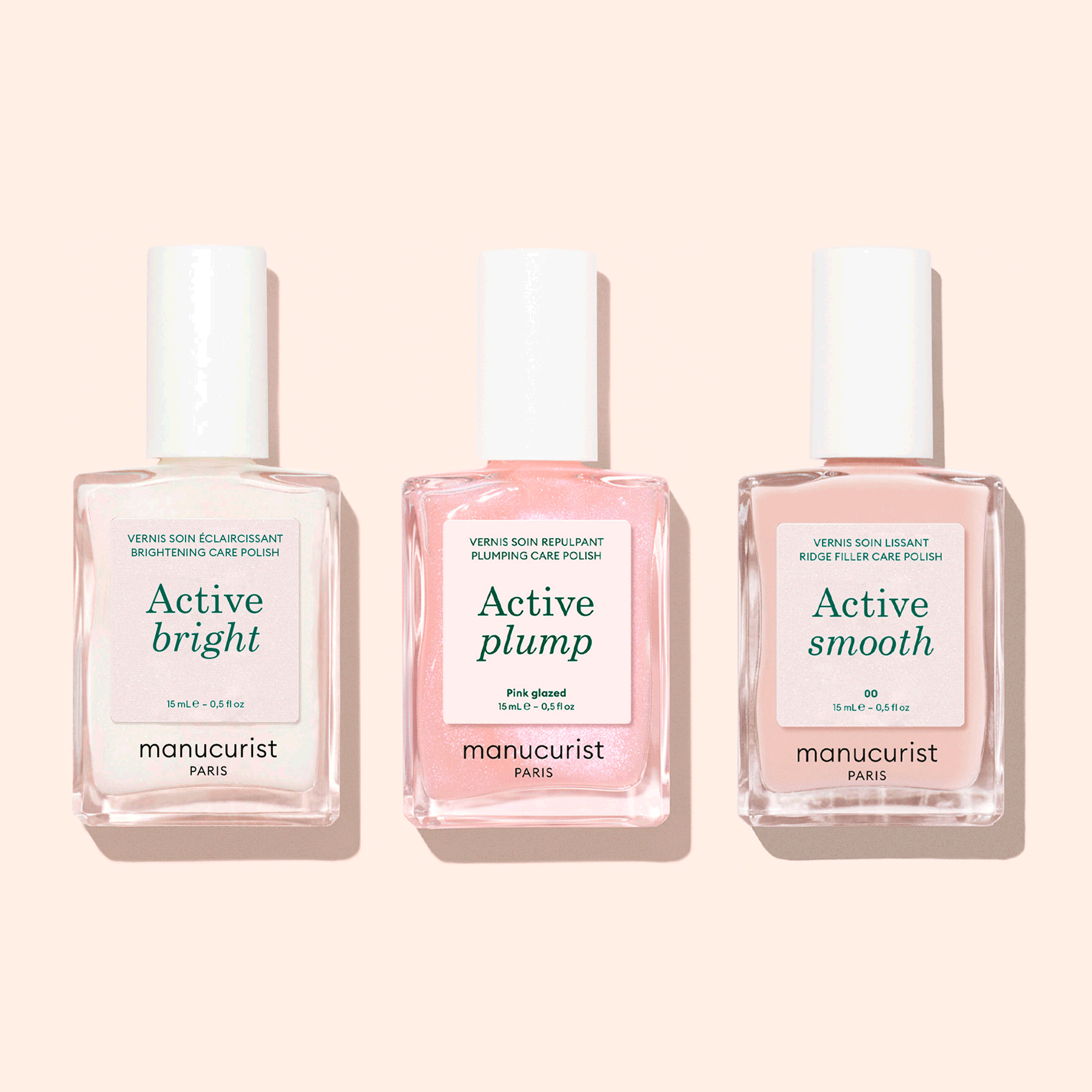 Three bottles of Manucurist Customisable Trio Active™ nail care polishes—Active Blur, Active Plump, and Active Bright—are displayed side by side on a light pink background, each delivering a unique effect for personalised nails.