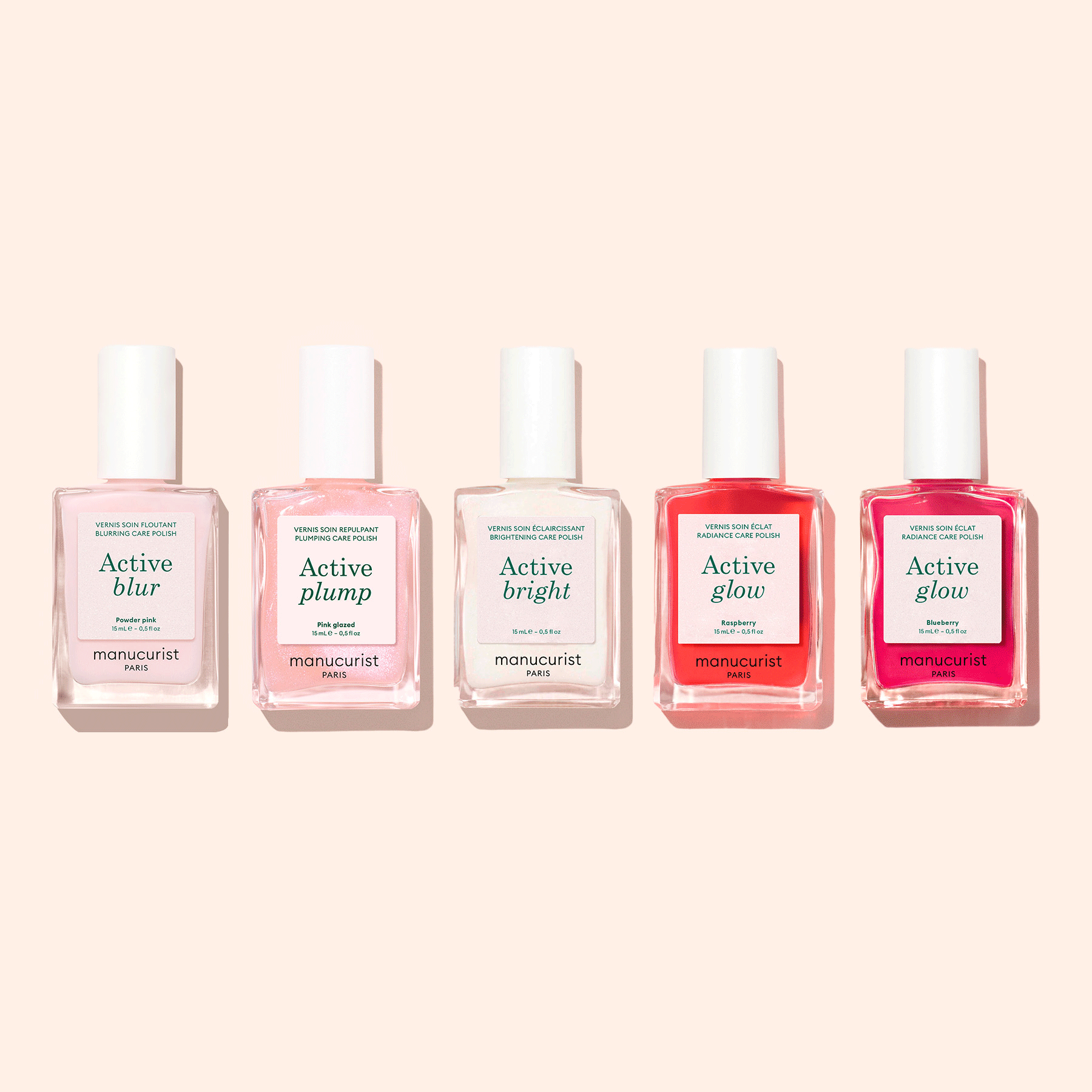 Five Manucurist Customisable Rainbow Active™ nail polishes are arranged against a light beige background, each offering unique effects—Blur, Plump, Bright, and two Glow—for a personalized manicure.