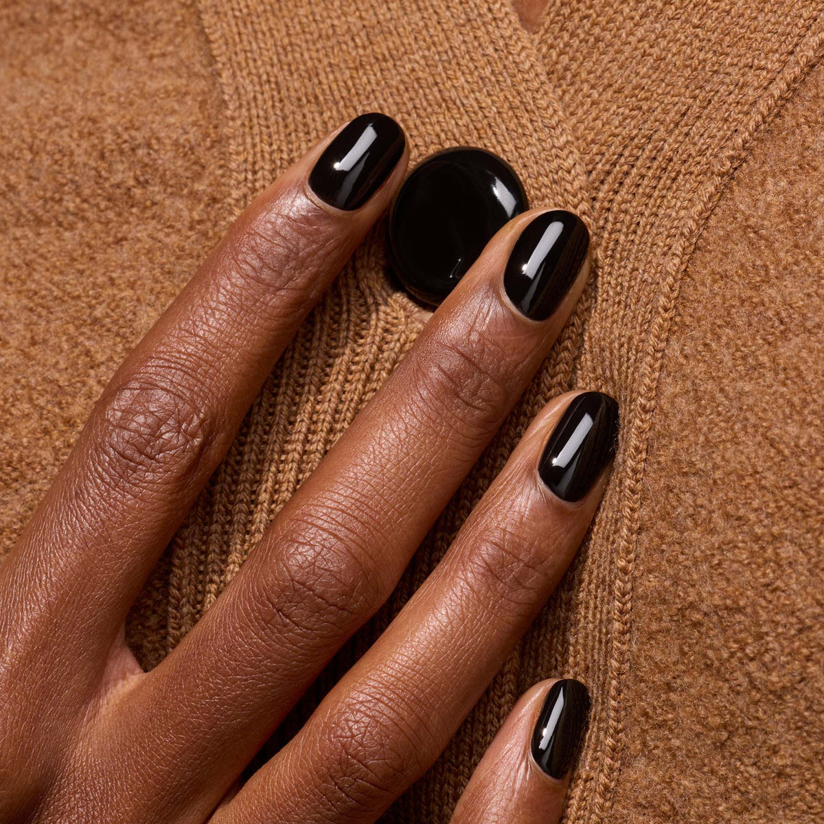 A hand with neatly manicured nails painted in Manucurist&