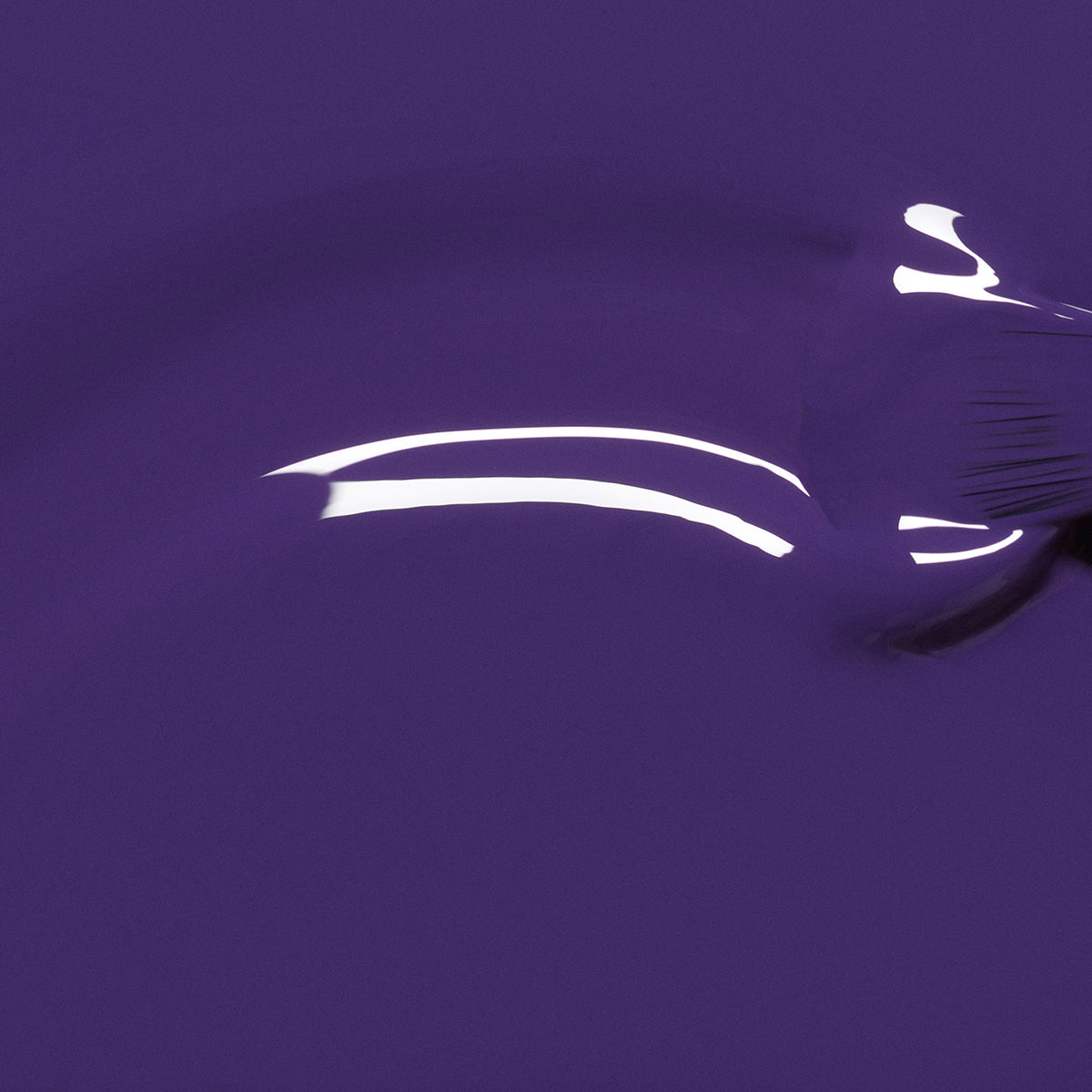 A close-up shows Manucurist’s Mystic, an opaque violet nail polish, brushed onto a smooth surface with visible strokes and glossy reflections.