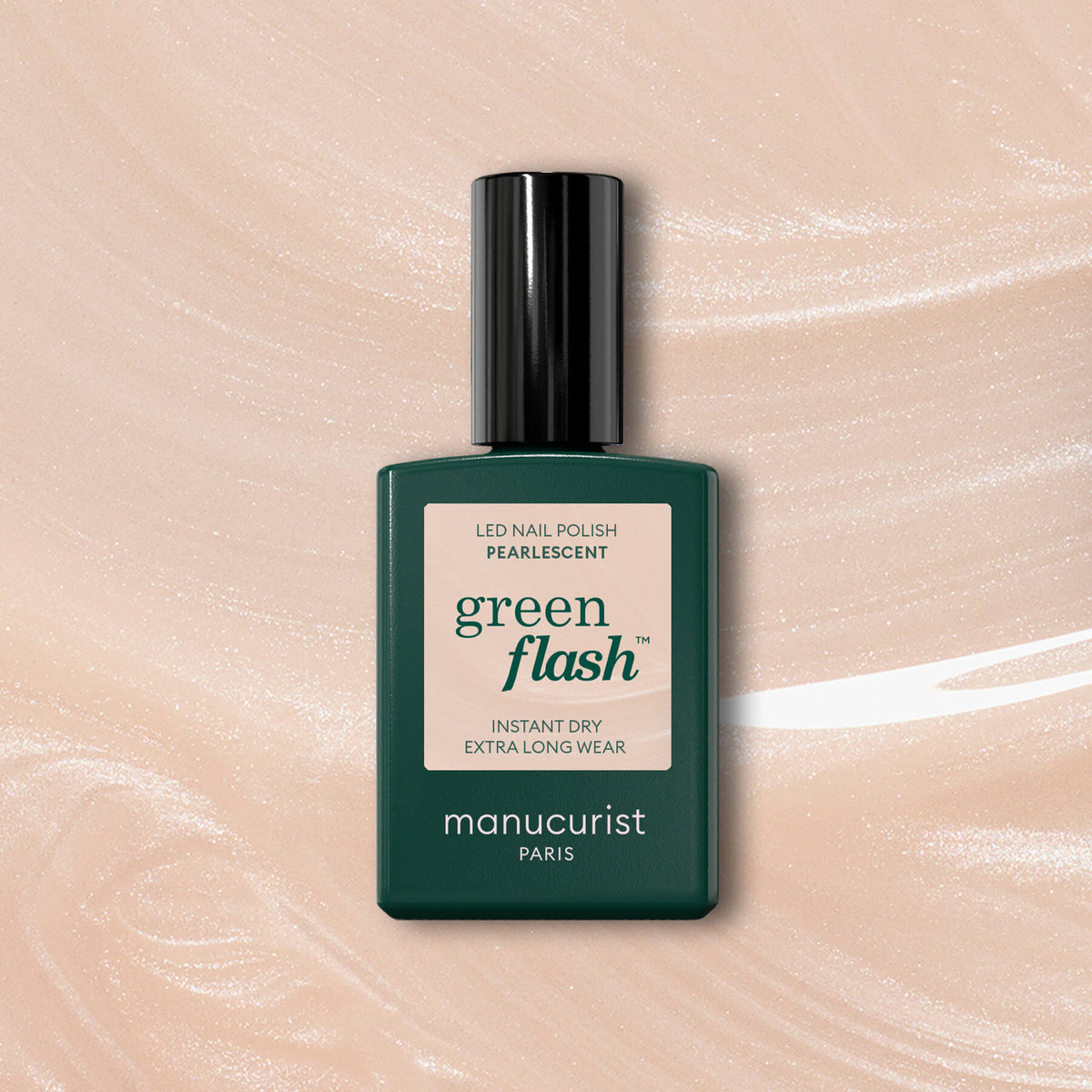 A bottle of Manucurist Pearlescent Green Flash LED Gel Polish with a dark green rectangular body and black cap is shown on a Pearly Beige shimmery background.