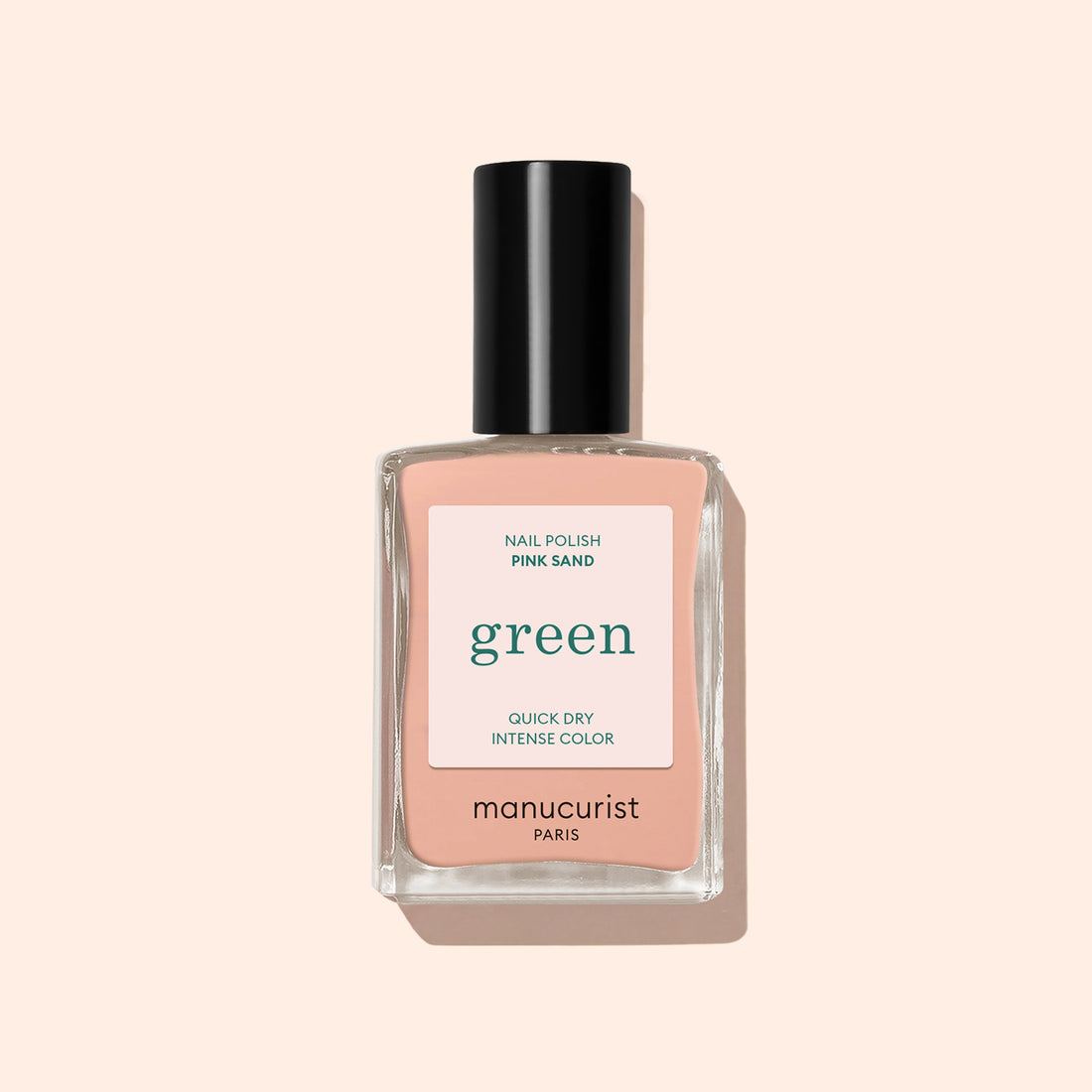 Manucurist Pink Sand nail polish features a peach-pink shade with subtle orange undertones in a clear rectangular bottle topped with a black cap.