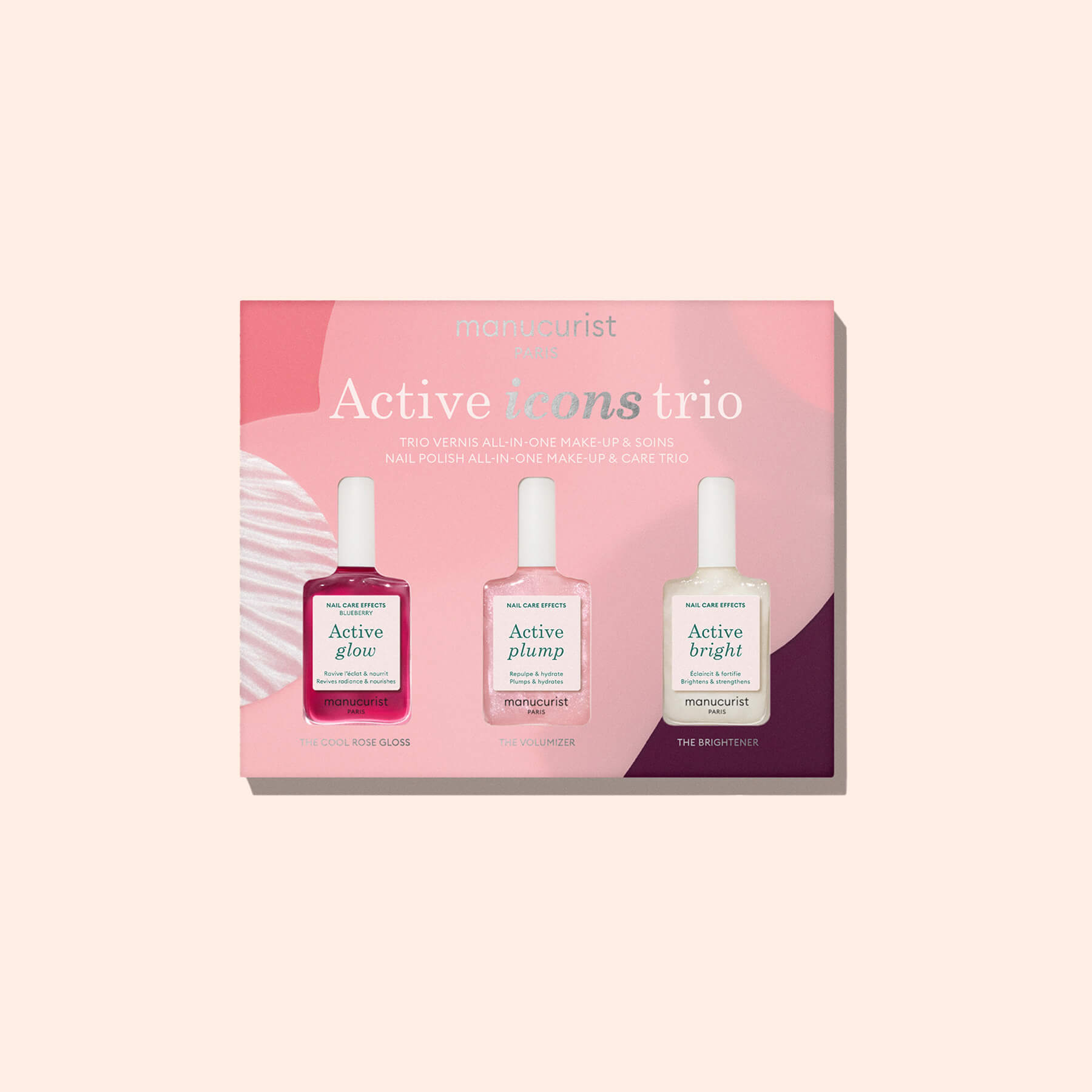 The Manucurist Active Glow Blueberry nail polish, made with a plant-based formula, is showcased against a pale pink background.