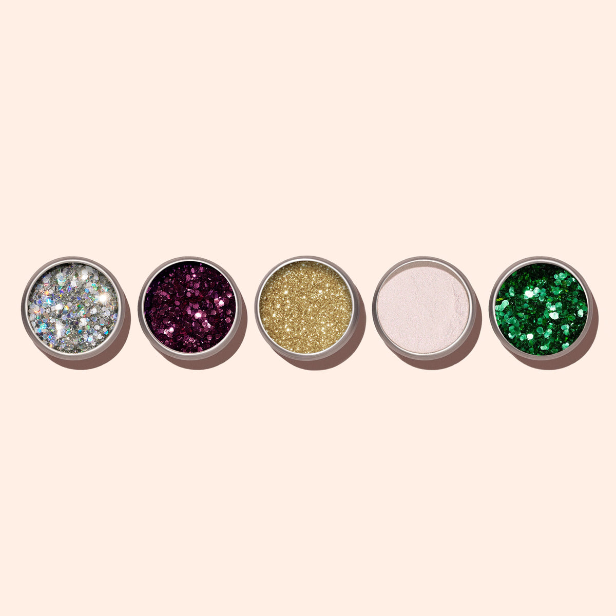 Five round pans from Manucurist, including Bordeaux biodegradable glitter, are arranged in a row on a light beige background. Perfect for adding eco-friendly sparkle to your gel or nail polish looks.