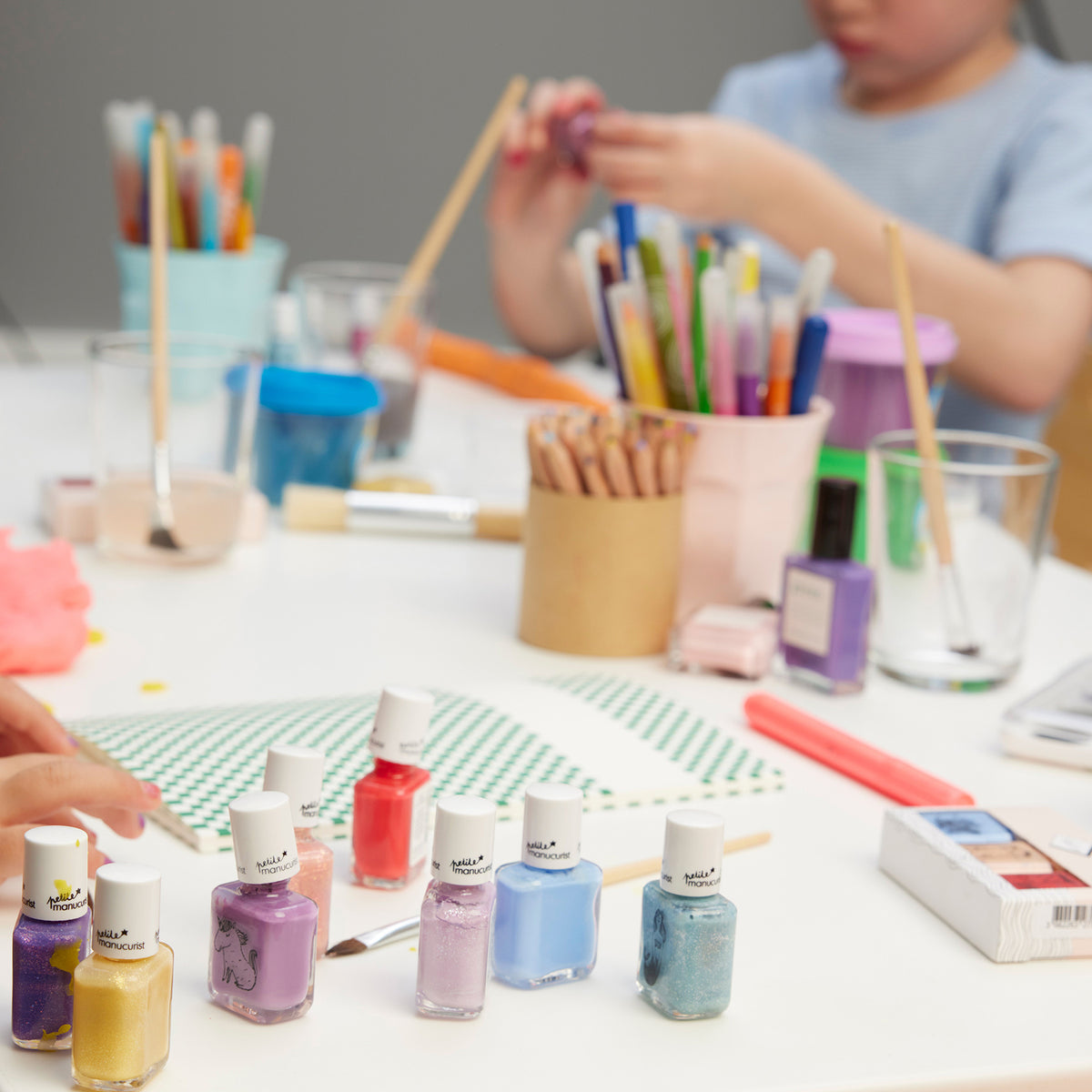 Children sit at a table with Manucurist&