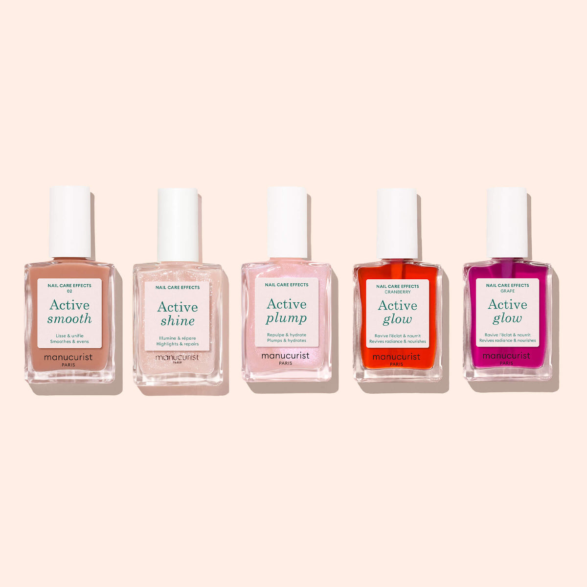 Five bottles of Manucurist nail care polish in a row, each labeled: Active™ Smooth 02, Active Shine, Active Plump, Active Glow (orange), and Active Glow (pink), with white caps, displayed on a light beige background—each one a perfecting treatment from Manucurist crafted to elevate your nail care routine.