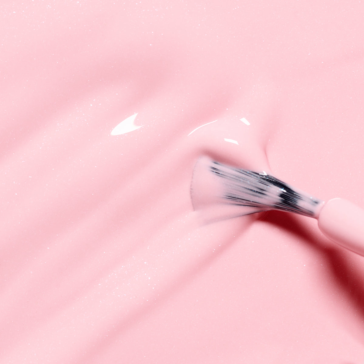 A close-up of a brush spreading Manucurist&
