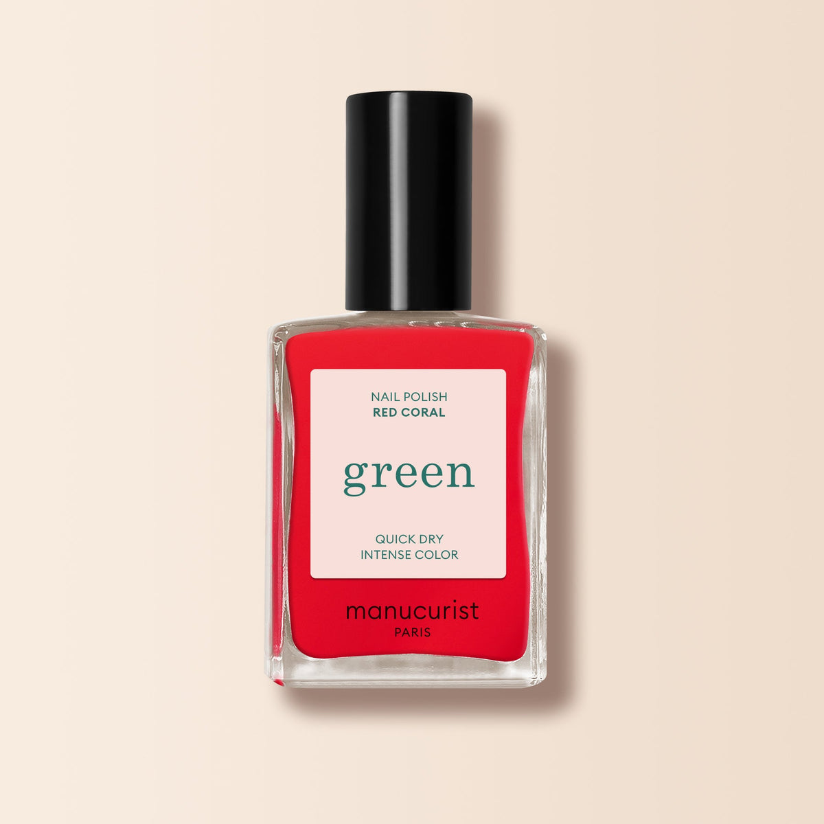 Manucurist Red Coral nail polish in a clear rectangular bottle with a black cap offers quick-dry, intense festive red color—a perfect pick for bold nails.