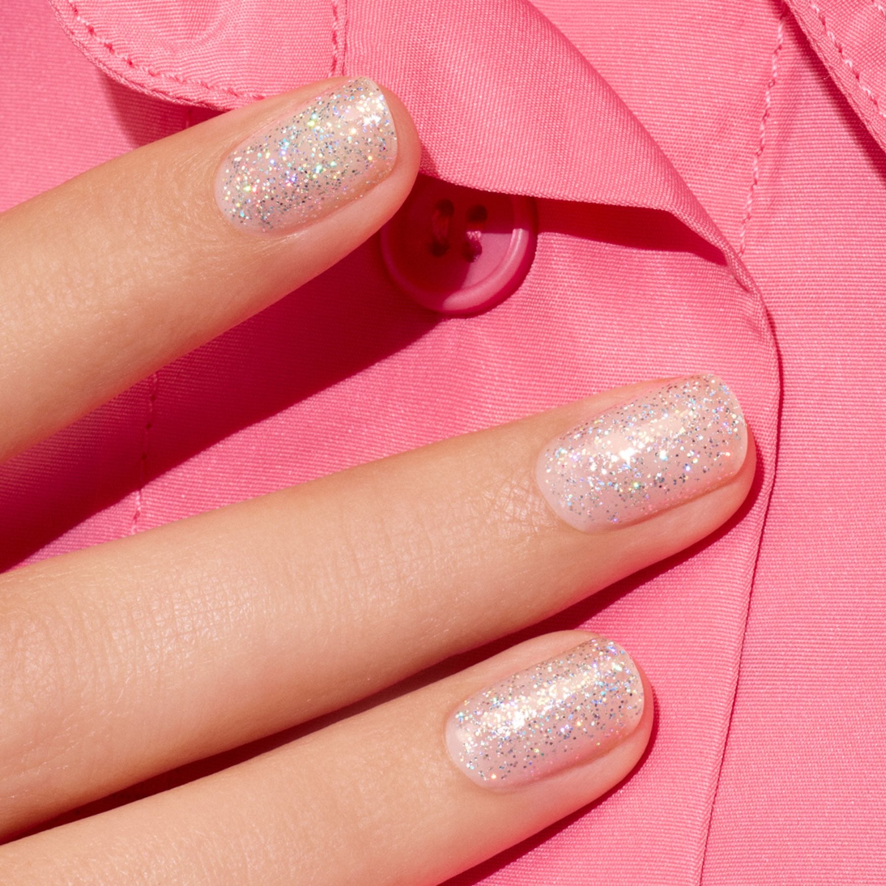 A close-up of a hand with short nails painted in Manucurist&