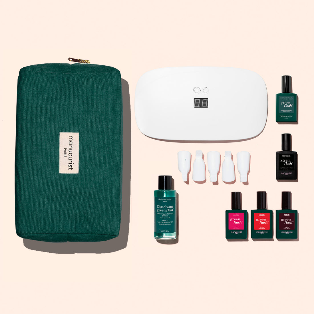 The Manucurist Starter Kit includes a green zippered pouch, white LED nail lamp, Green Flash gel polish, four colored polishes, Vitaminized Base Coat, ultra-glossy top coat, remover, and four nail care tools.