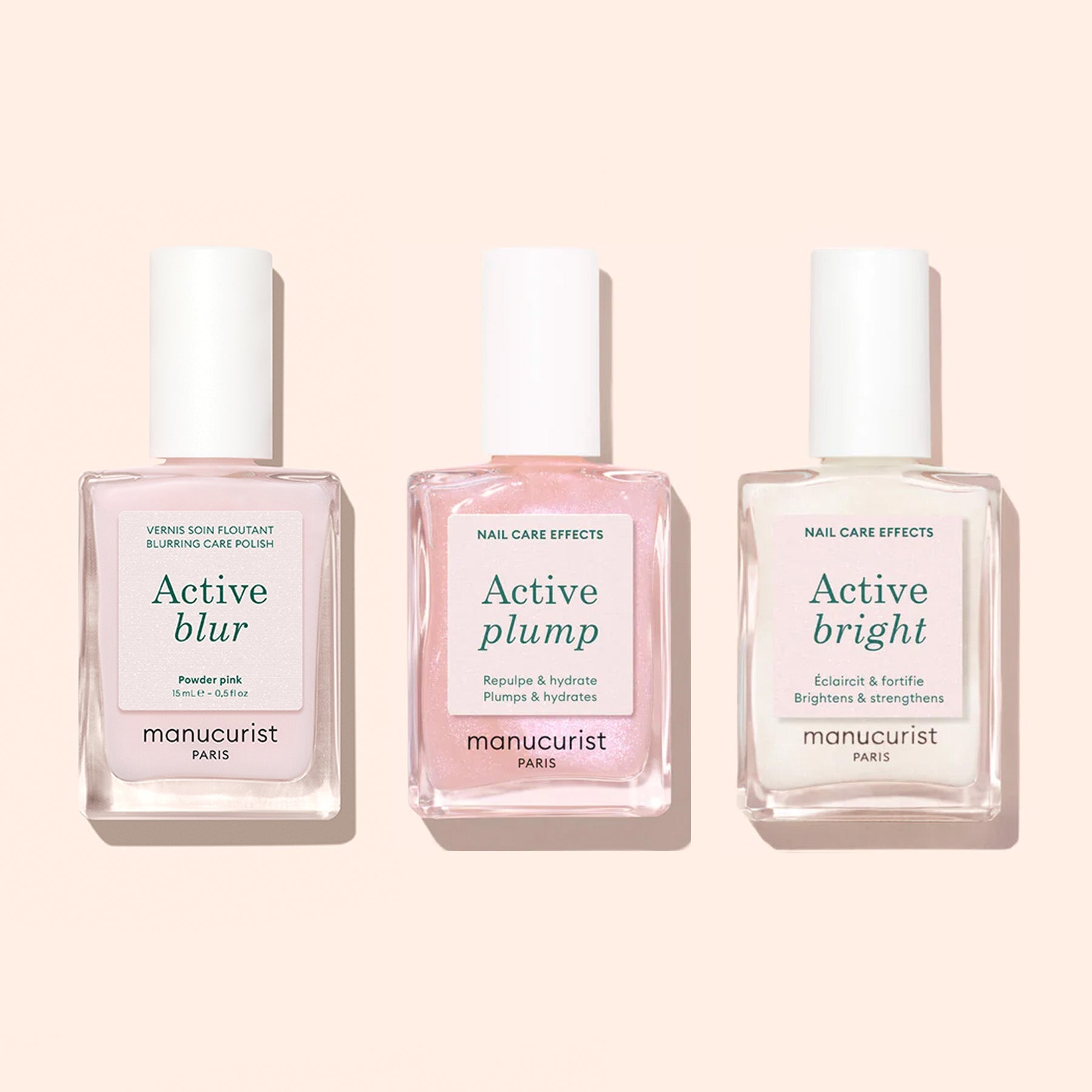 Three bottles of Manucurist Active Blur are displayed upright on a light beige background, showcasing their nail-enhancing formulas and blurring care polish benefits.