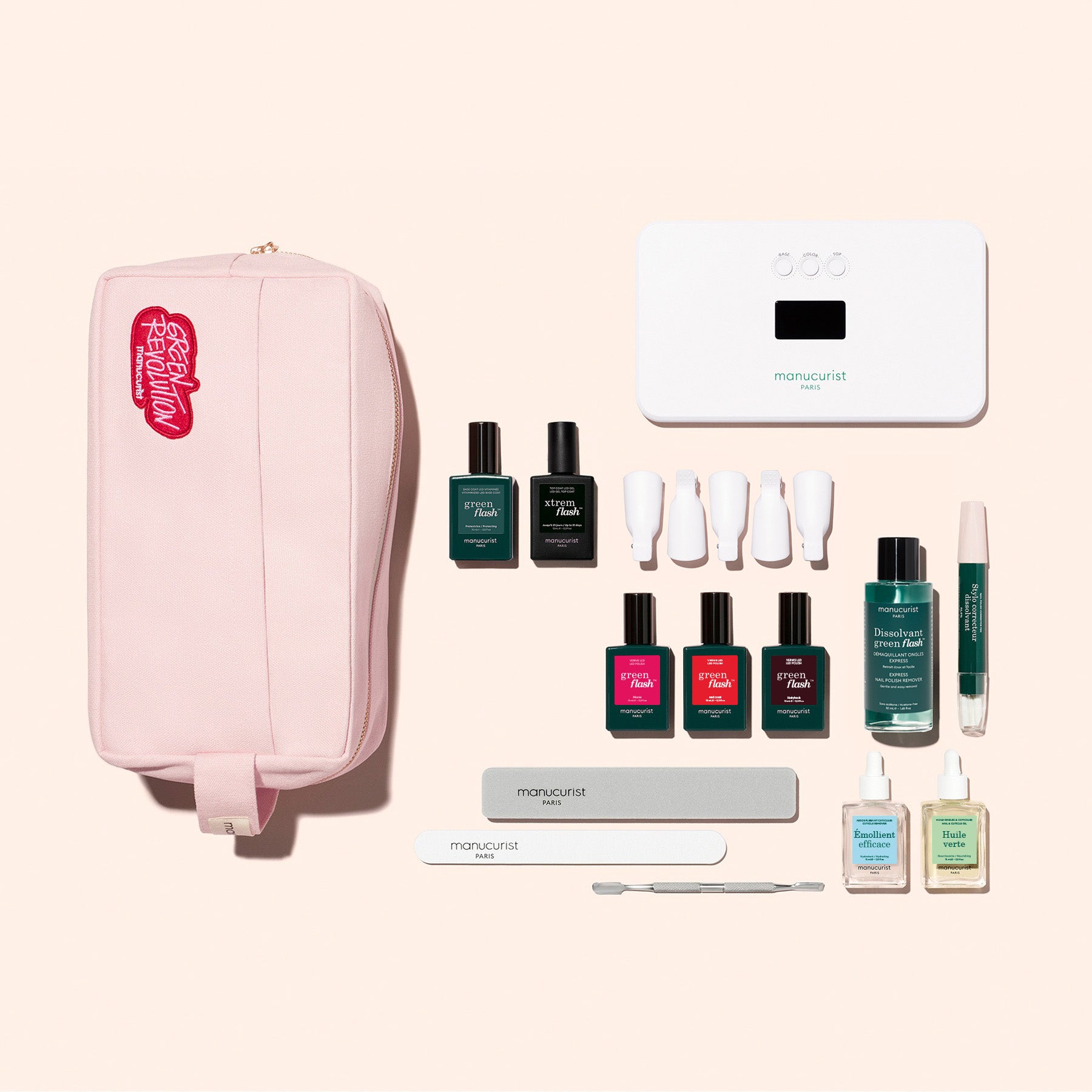The Manucurist Addict Kit features a pink zippered pouch, six Green Flash gel polishes, three white-capped bottles, a green pen, white nail lamp, two nail files, cuticle pusher, and four small nail care essentials for an ultra-glossy manicure.