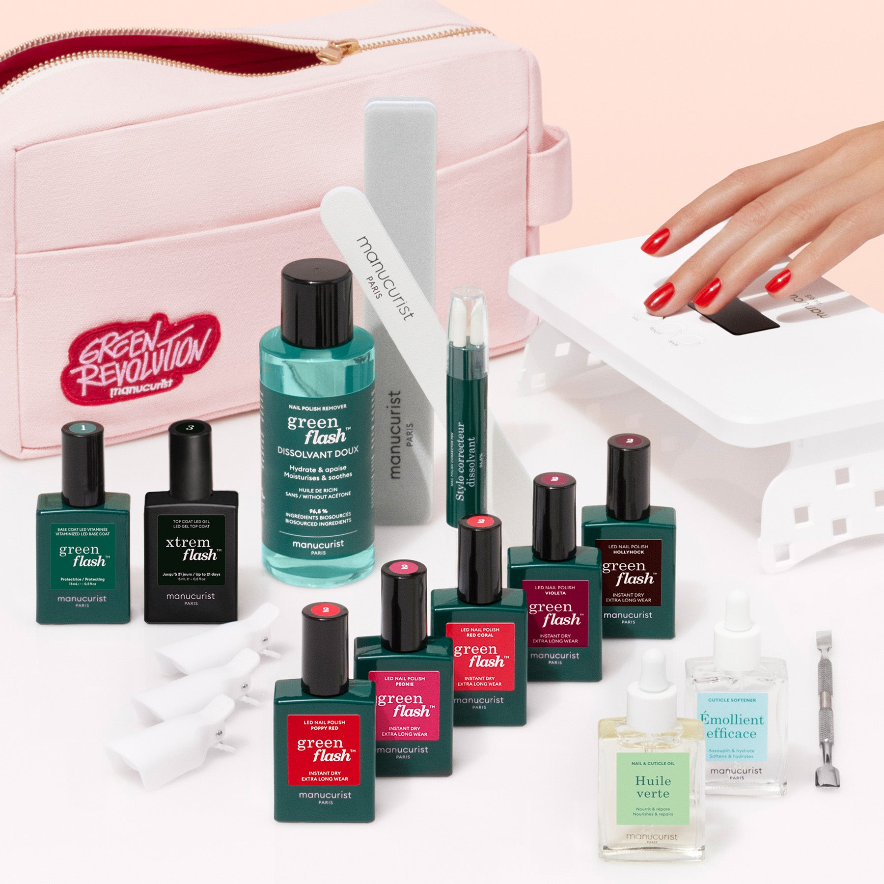 The Manucurist Super Addict Kit includes gel polish, nail care bottles, a file, buffer, cuticle pusher, pink pouch, and UV lamp. A hand with painted nails is shown under the lamp for an ultra-glossy manicure.