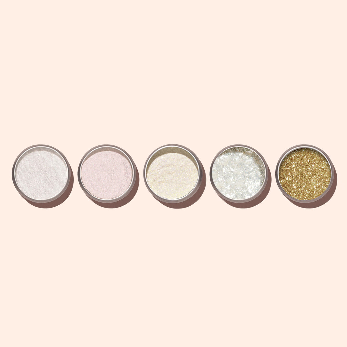 Five small round jars of Manucurist White Glazed Effect Powder, in white, pale pink, cream, silver, and gold shades—ideal for chic glazed manicures—are arranged in a row on a light beige background.