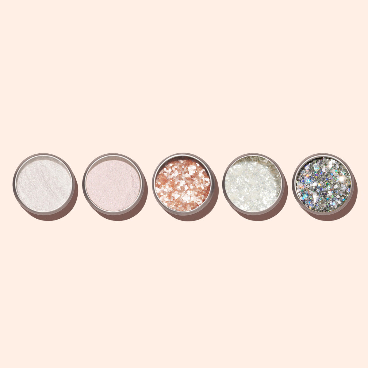 Five Nacres Flakes containers by Manucurist, filled with shimmery powders or pearlescent flakes in white, pink, rose gold, silver, and holographic—perfect for sparkling manicures against a light beige background.
