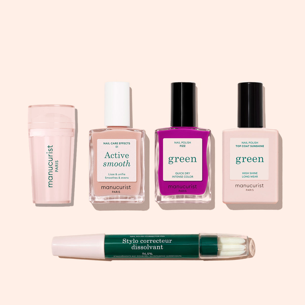 The French Colour Kit includes five Manucurist nail care products—a cuticle serum, Active Smooth bottle, bright pink polish, top coat, and correcting pen—perfect for mastering French tips on a chic light beige background.