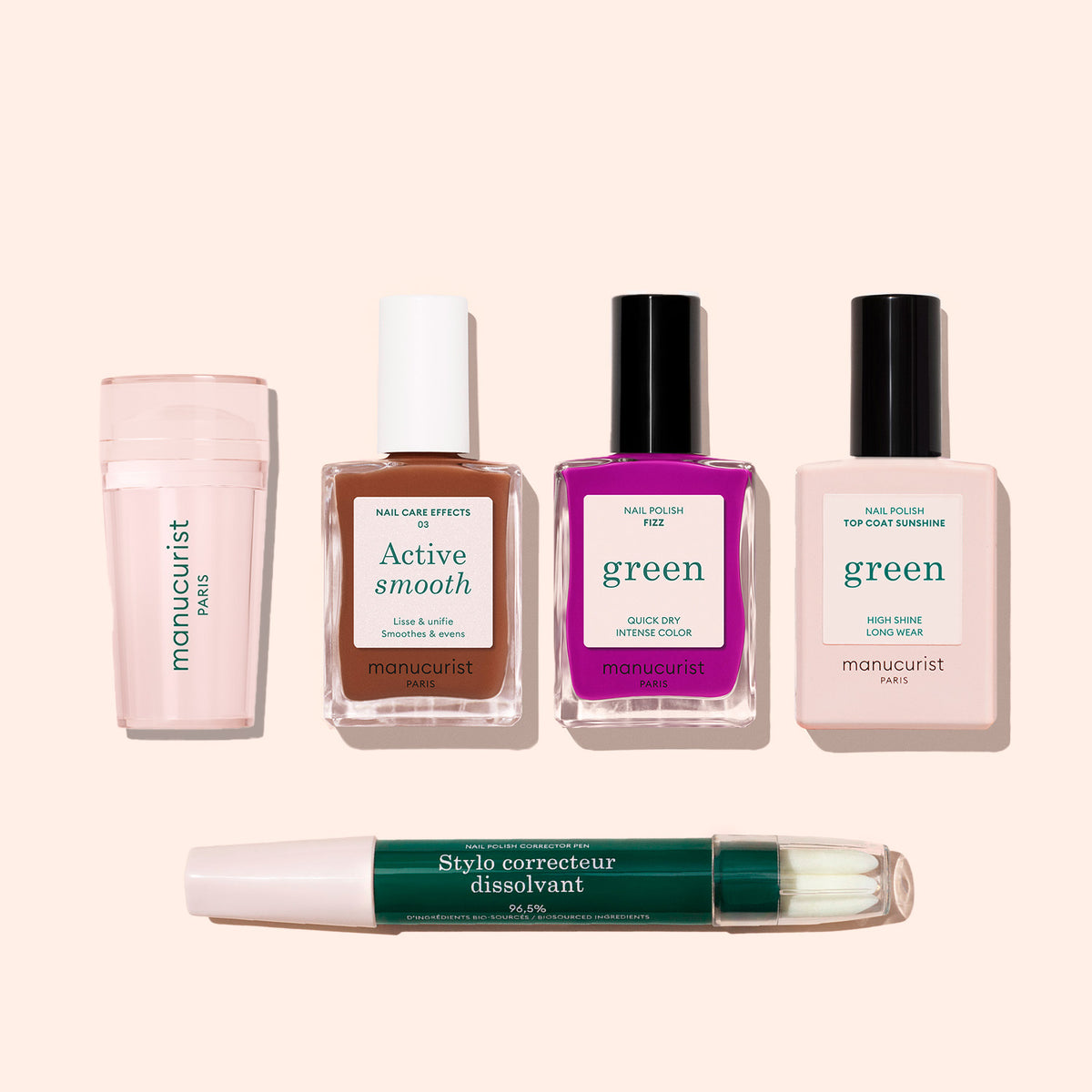 The French Colour Kit from Manucurist showcases five manicure essentials—cuticle remover, ridge filler, fuchsia polish, top coat, and correcting pen—on a pastel pink backdrop for the perfect at-home nail kit.