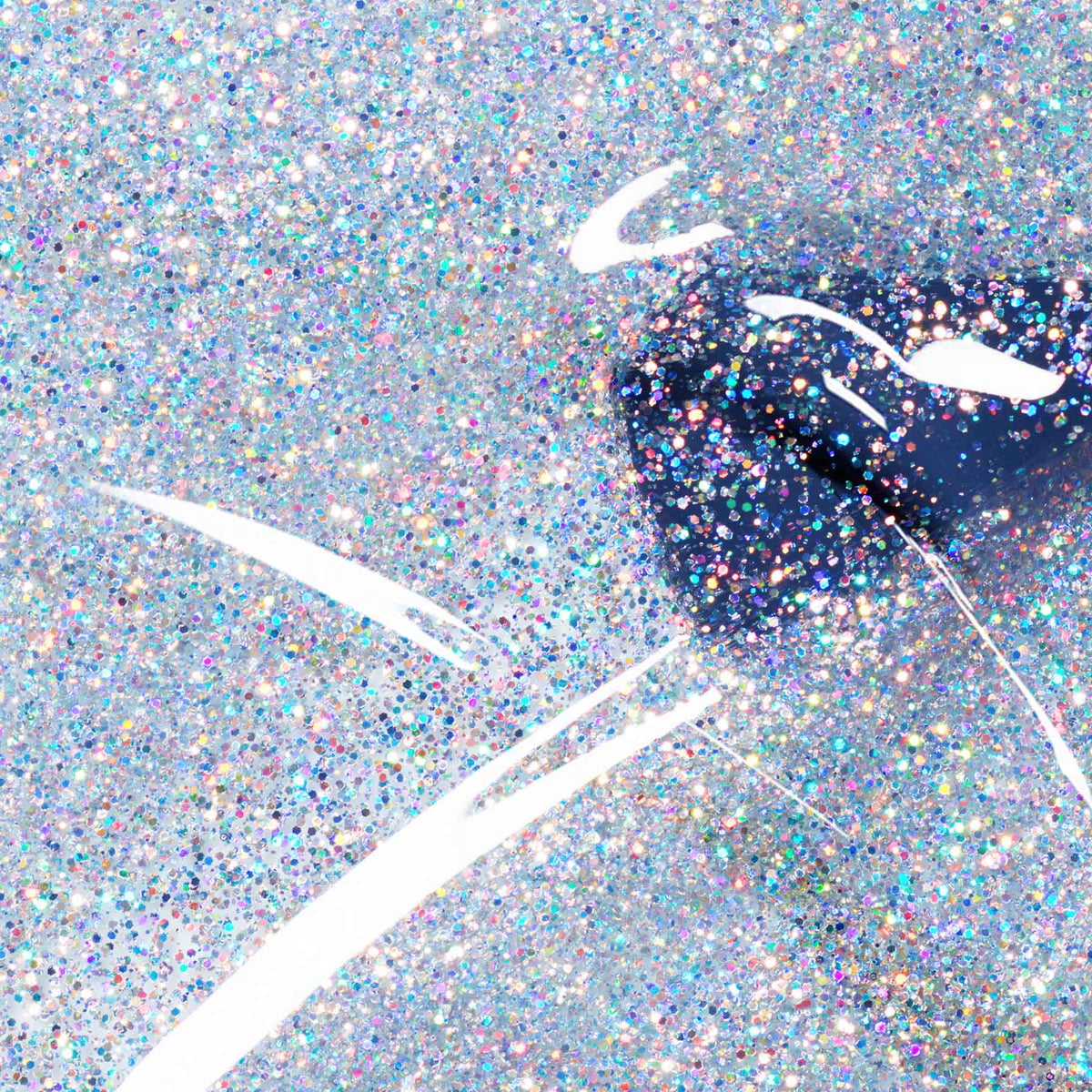 Close-up of glossy lips coated in Manucurist’s Midnight Swim, a dark blue shade, surrounded by multicolored glitter for a shimmering festive look. White highlights emphasize the shine on the lips.