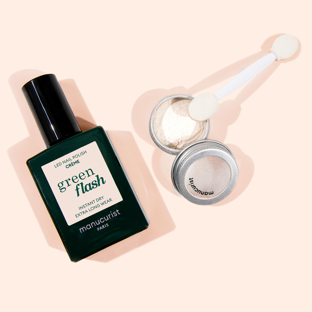 The One Only Duo by Manucurist—a dark green nail polish and Glazed Effect Powder with applicator—rests on a light beige background, perfect for creating an ultra-glowy manicure.