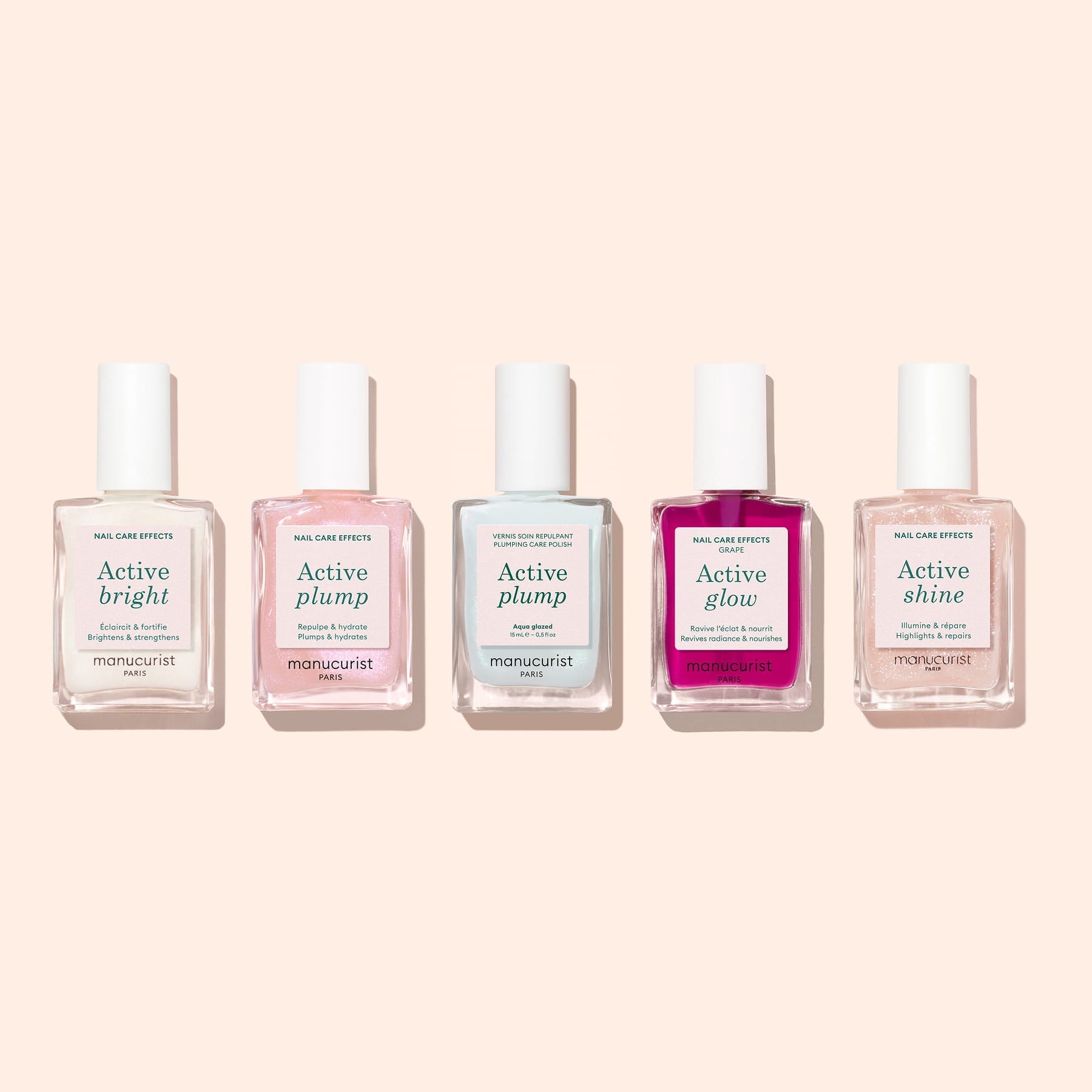 Five Manucurist nail care bottles stand against a light beige background, each labeled for effects—Active Bright, Active Plump Aqua Glazed (two), Active Glow, and Active Shine—with collagen polish for healthy, hydrated nails.