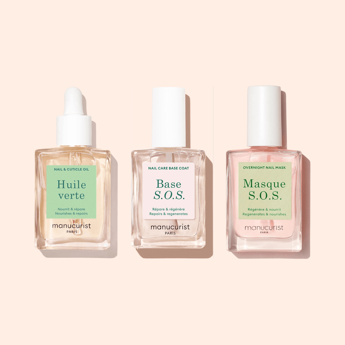 Three glass bottles with white caps on a beige background display Manucurist’s Nourishing Cuticle Oil—ideal for hydrating nails and caring for cuticles with its nourishing formula.