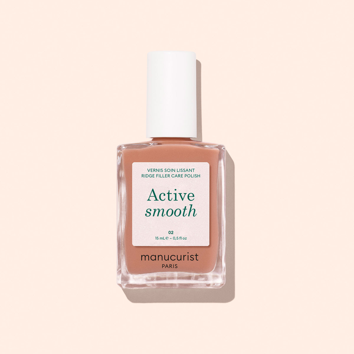 A bottle of Manucurist Active™ Smooth 02 nail care polish, featuring a white cap and set against a light beige background—an ideal perfecting treatment for flawless nails.