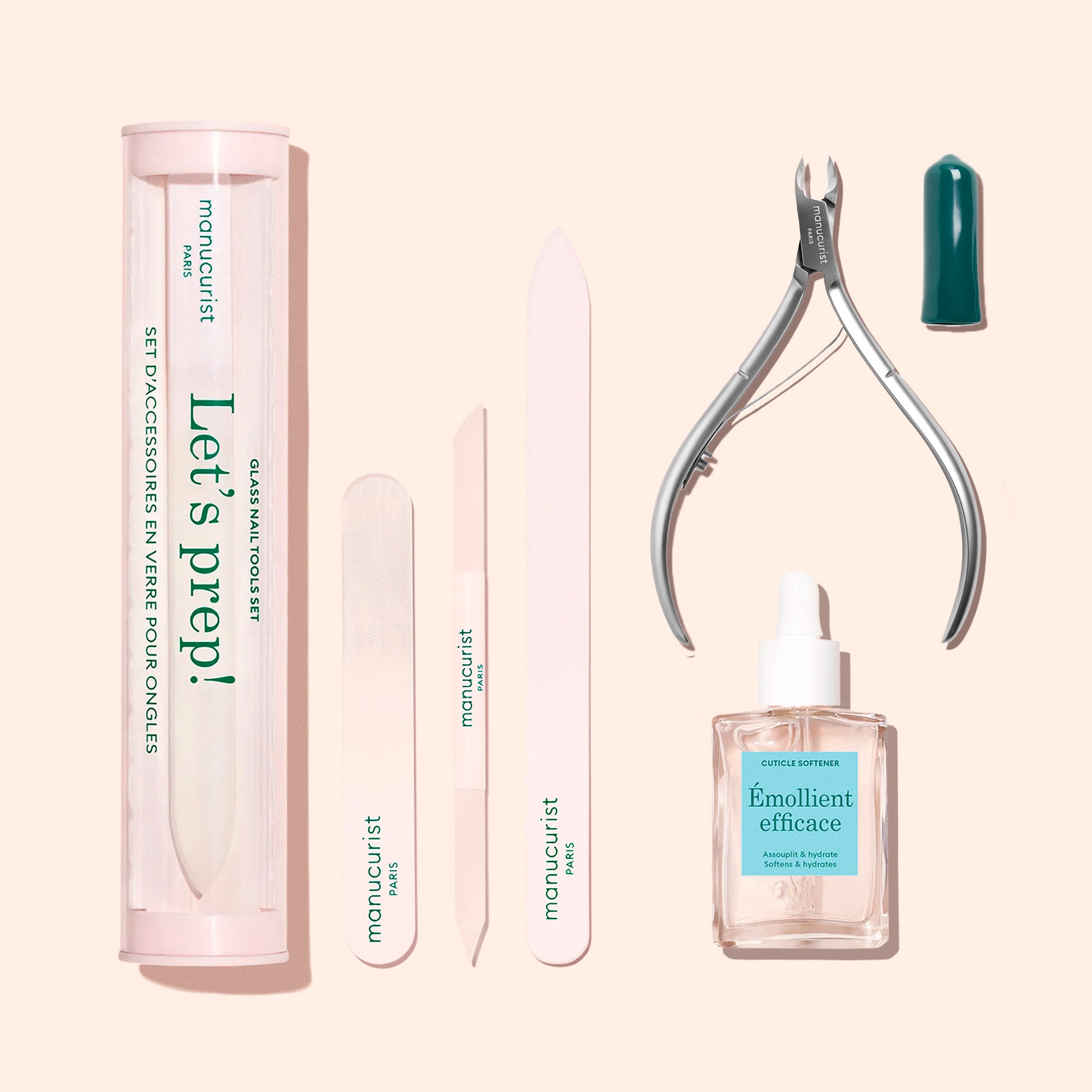 The Manucurist Nail Prep Set features an emery board, buffer, cuticle pusher, cuticle cutters, cuticle remover bottle, and a cylindrical storage case, all neatly arranged on a beige background.