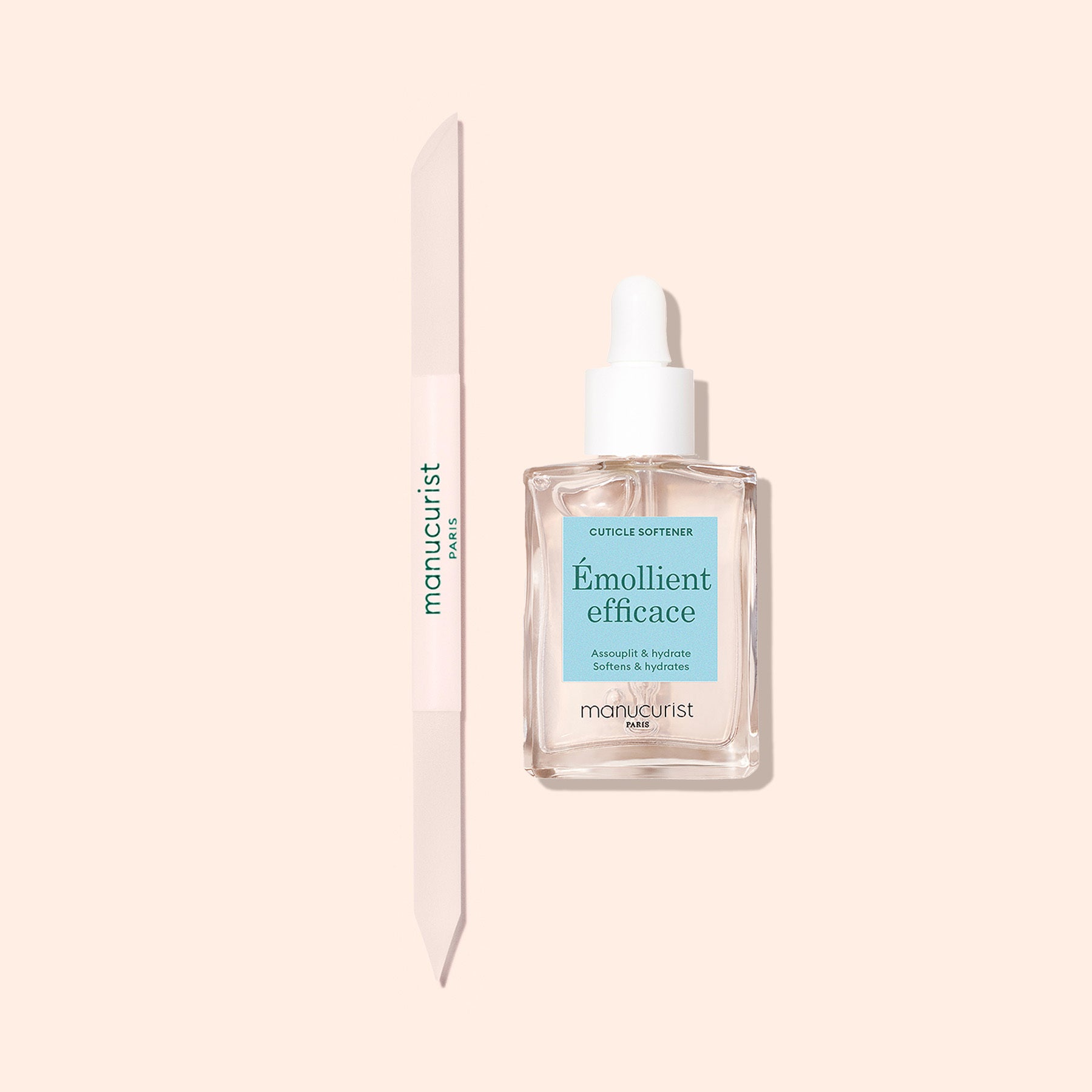 A Manucurist Glass Cuticle Pusher and a clear cuticle softener with dropper are displayed on a light beige background—must-haves for precise nail contouring and cuticle care.